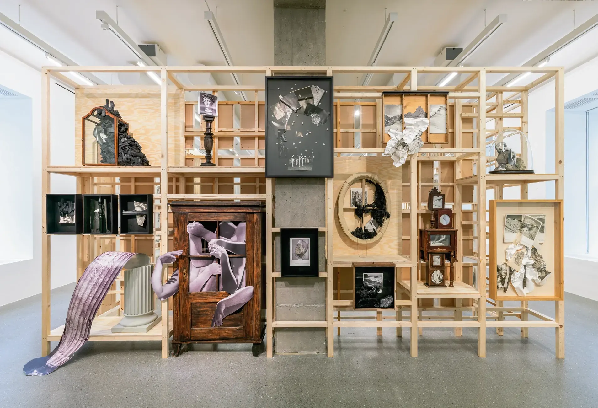 Lucia Tallová, PalaisPopulaire, Berlin: wooden lattice structure holding collages, framed works and a cabinet.