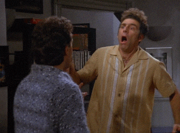 Kramer bursts into a room looking shocked — a comic reaction to the debate about separating art from politics.