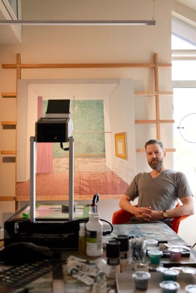 Chris Cassimatis sitting in his studio beside painting tools and a work in progress during an interview with DiFranco for Catapult Munchies Art Club.