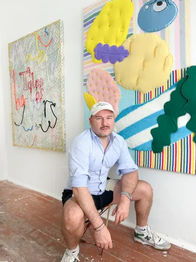 Daniel Ferstl, artist in focus on Catapult Contemporary , Vienna emerging artist spotlight in his studio with textile works on the walls , artist portrait