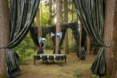 Katharina Busl, Nothing Up My Sleeve, Paltz Biënnale Soest 2026, wide installation view with camouflage curtains in pine forest