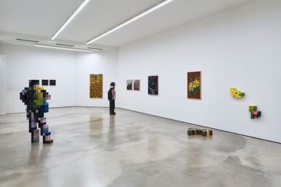 Catapult Contemporary Artist Profile Feature: Jaebum Joo, studio practice and artwork at Hakgojae Gallery, Seoul, 2026. Gallery view with two wood-block figures and wall-mounted pixel panels.