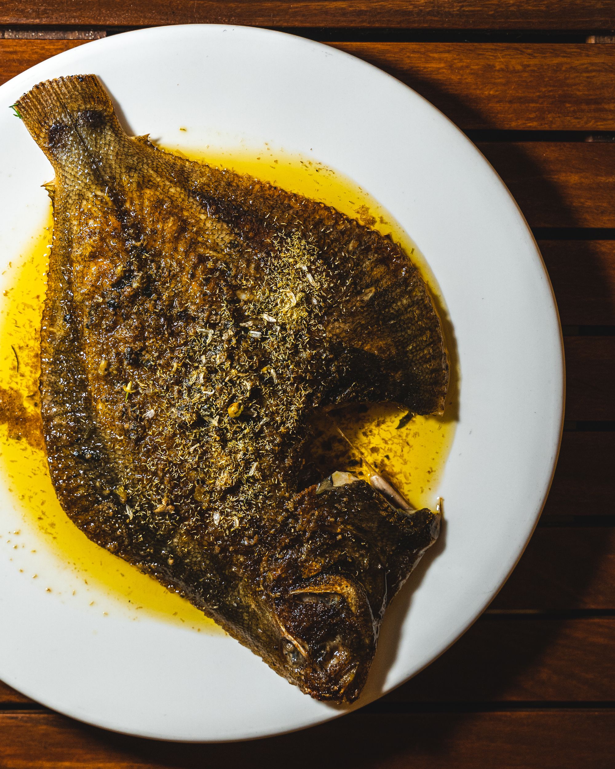 Overhead view of a grilled fish served on a plate