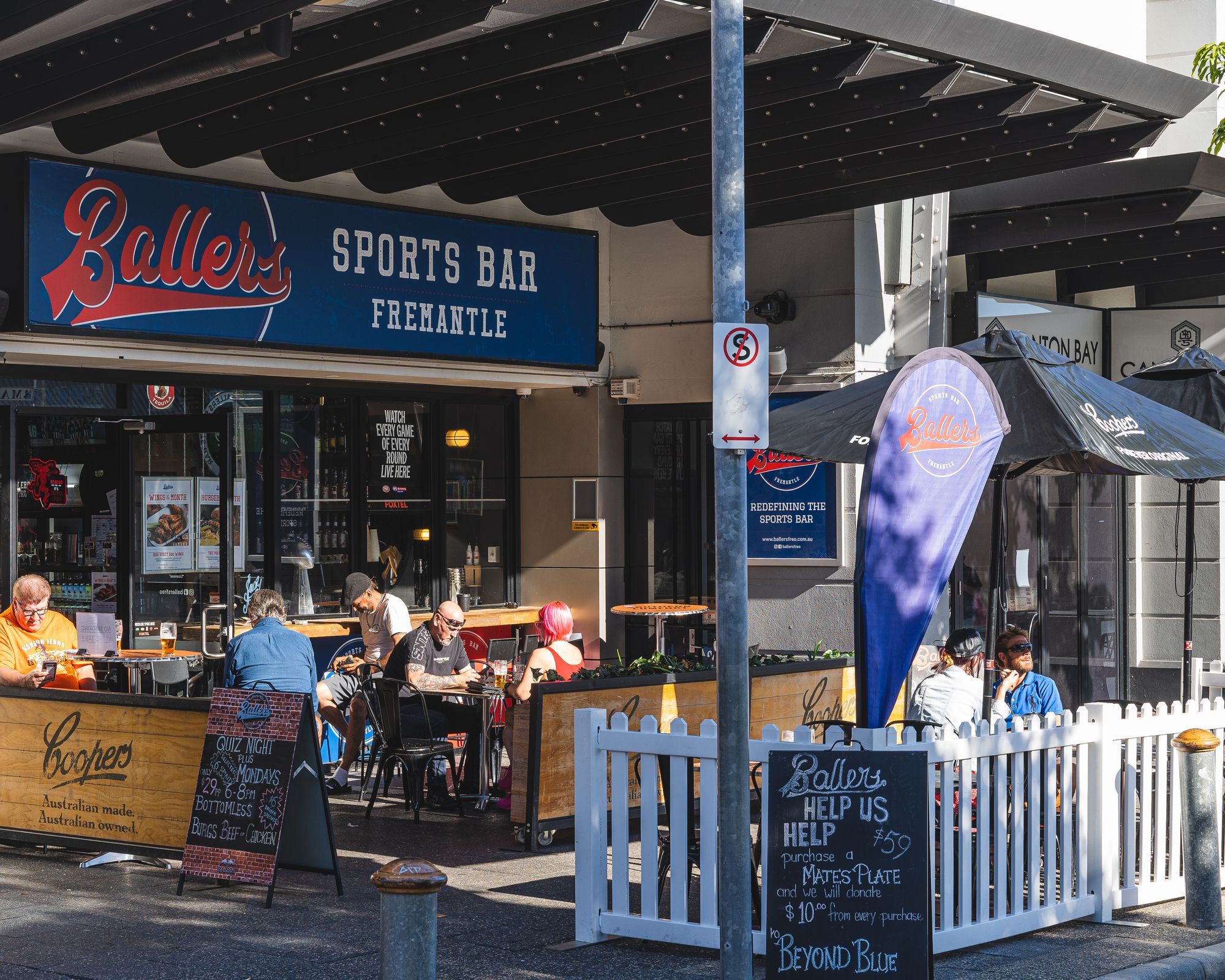 Exterior photo of Ballers Sports Bar Freo with guests sitting outside
