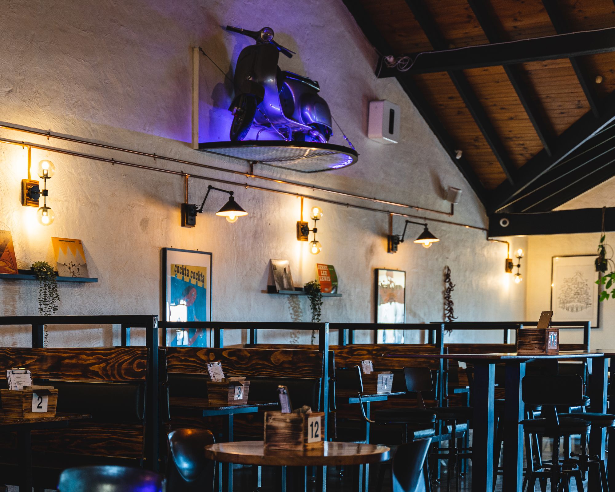 Interior shot of CHICH showing booths and a vespa scooter on a shelf