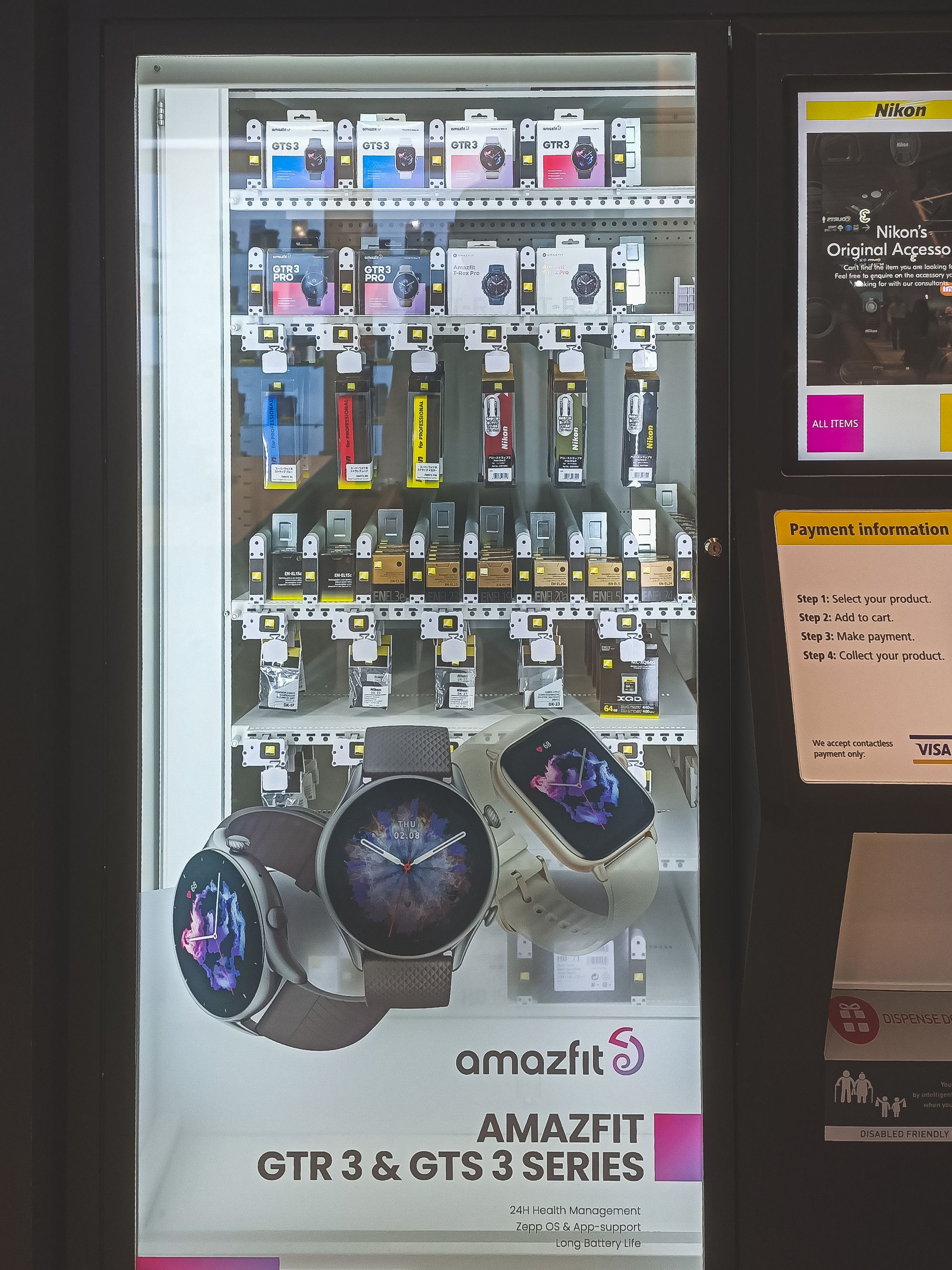 A vending machine selling a number of camera accessories and smart watches