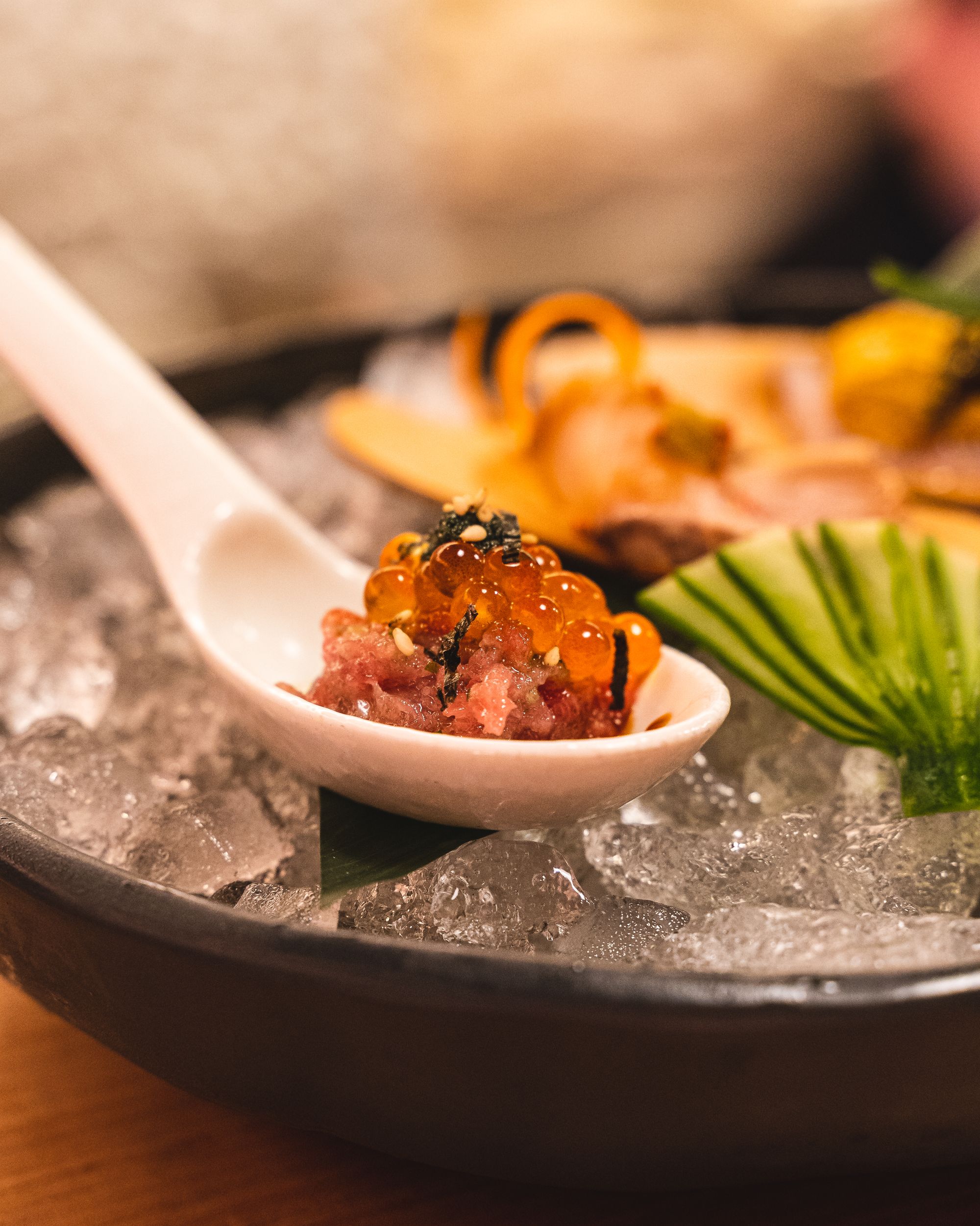spoon with toro tartare, ikura and strands of nori