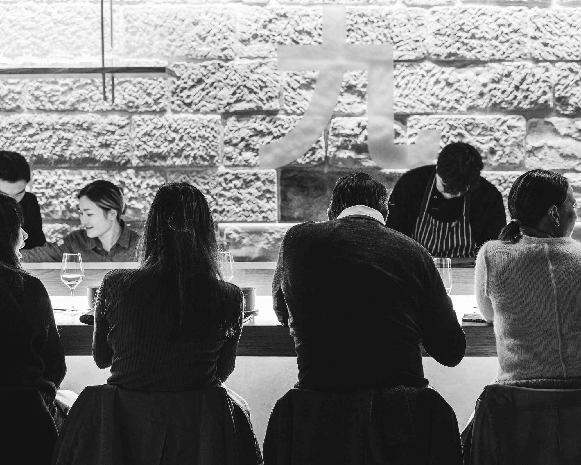 Black and white photo showing guests at Bay Nine eating food