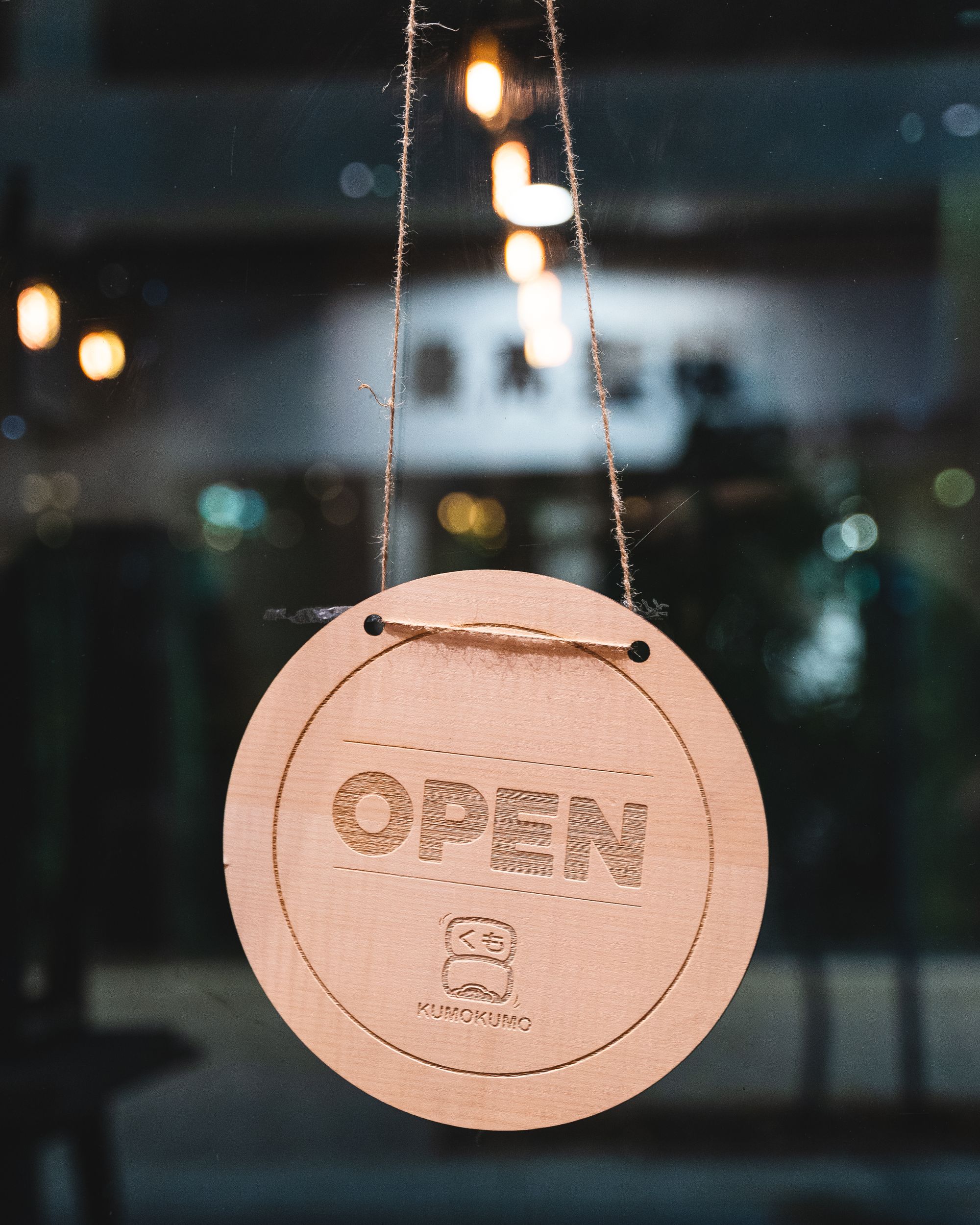 An open sign with Kumo Kumo printed on it