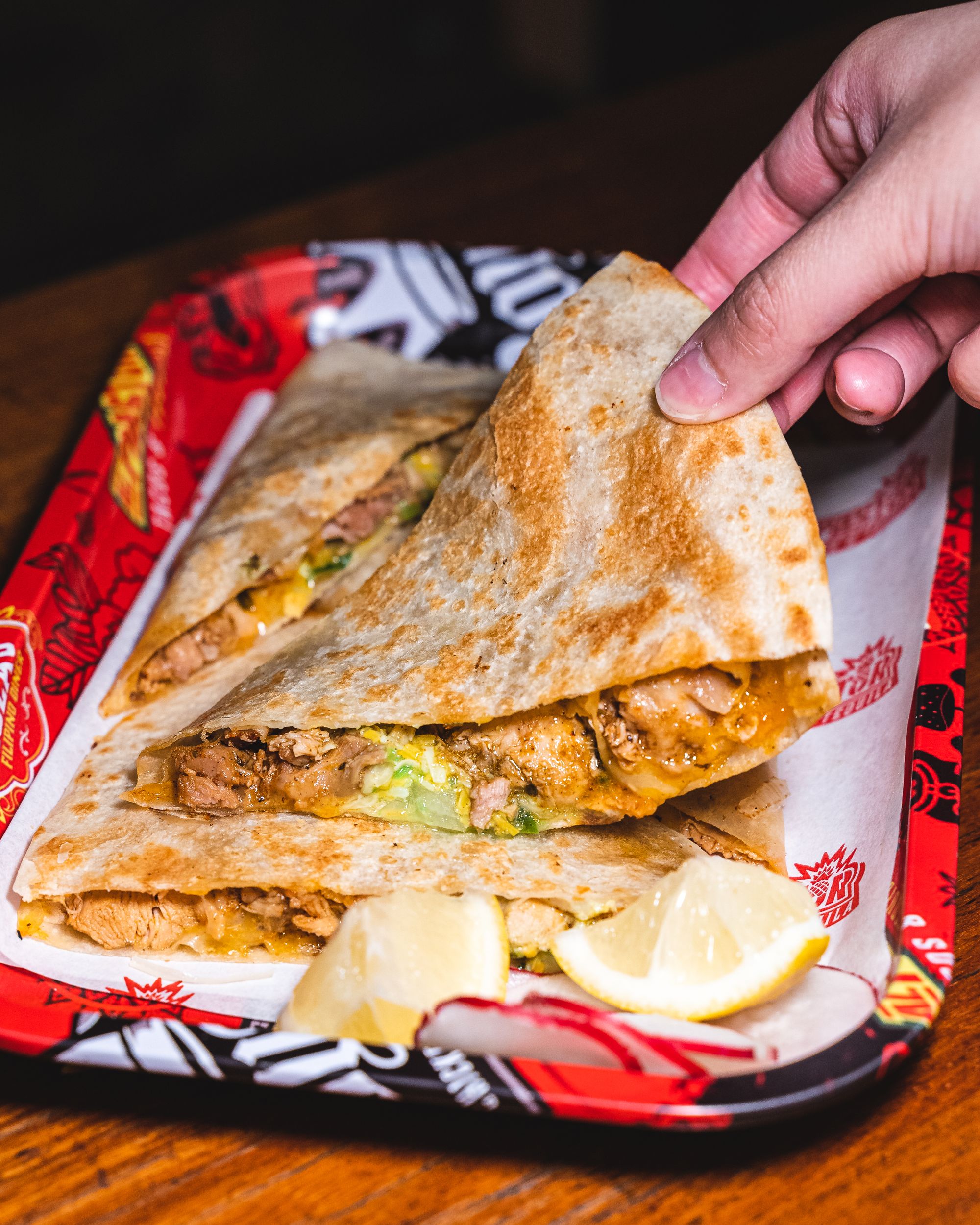Hand lifting up chicken quesadillas