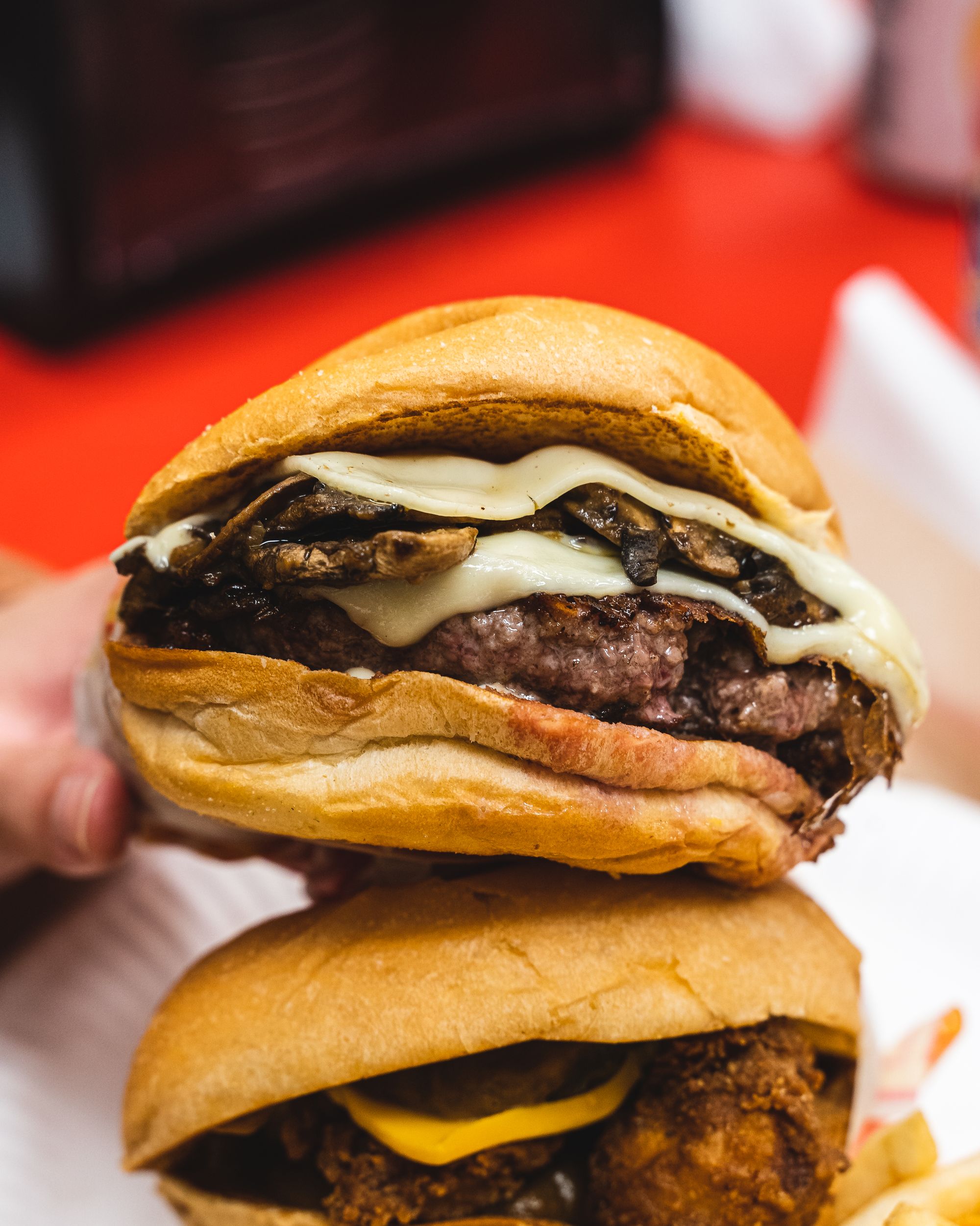 Close up of burger showing melted cheese oozing out
