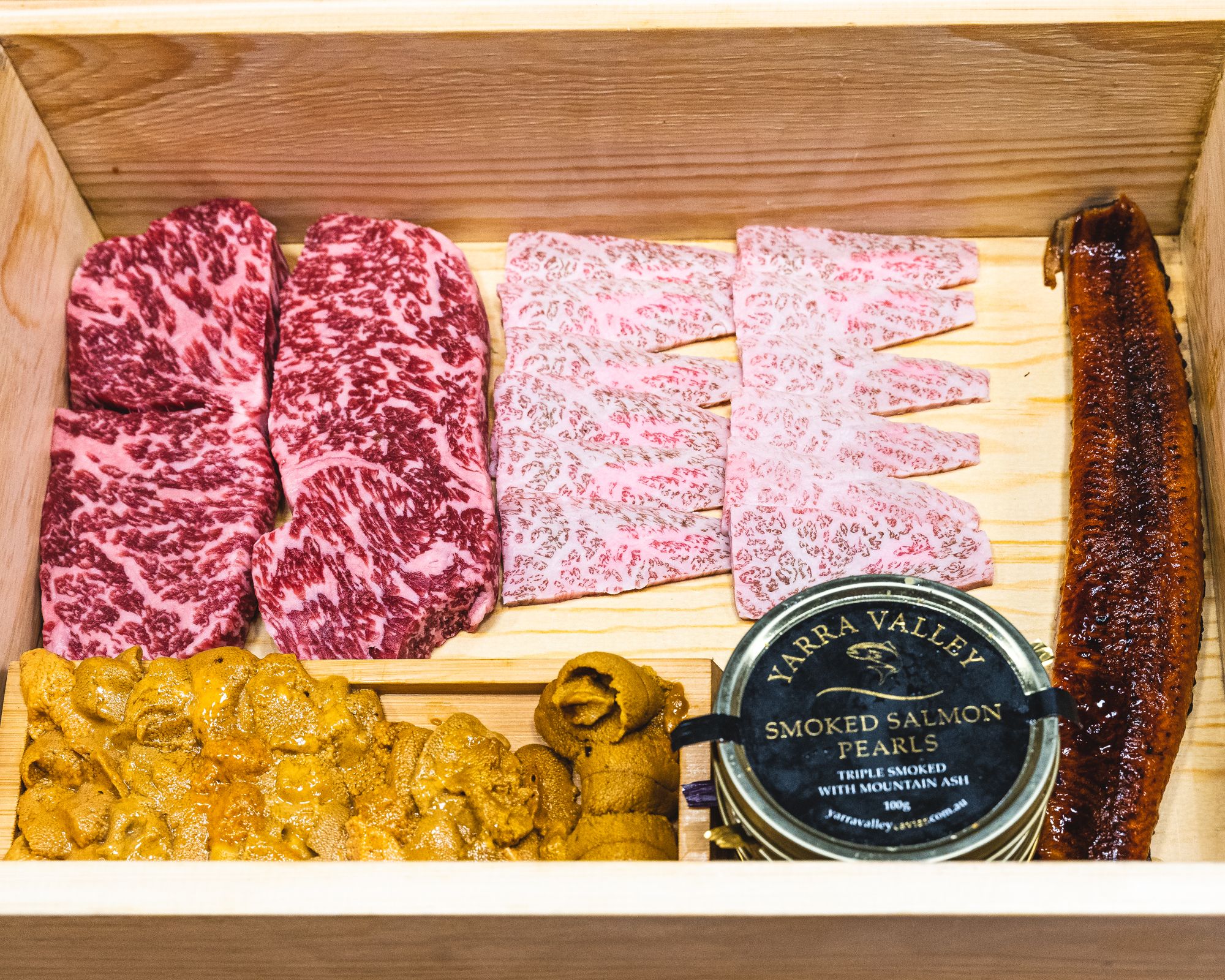 Wooden box with wagyu, Japanese wagyu, eel, sea urchin and a tin of salmon caviar