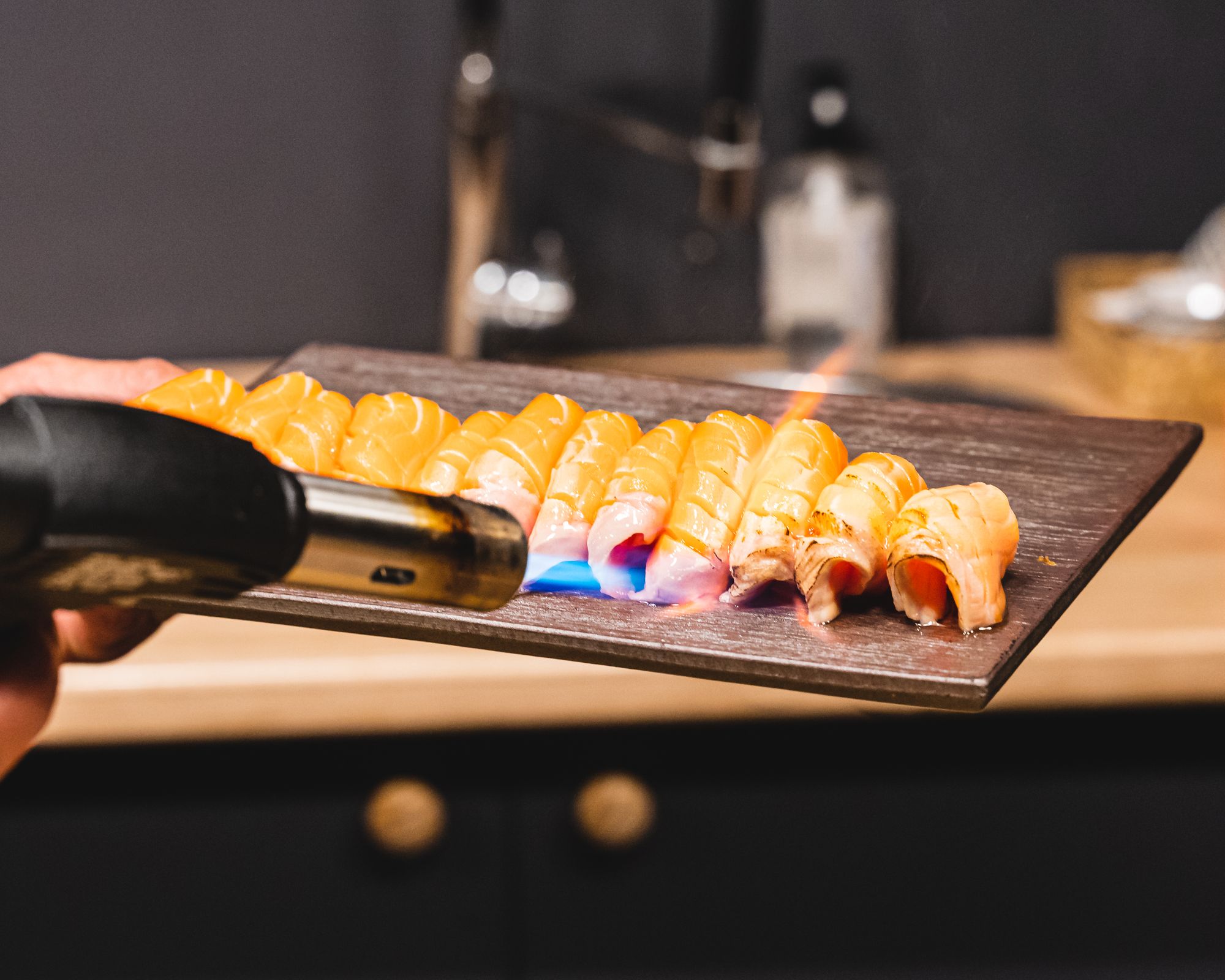 Blow torch searching salmon sashimi