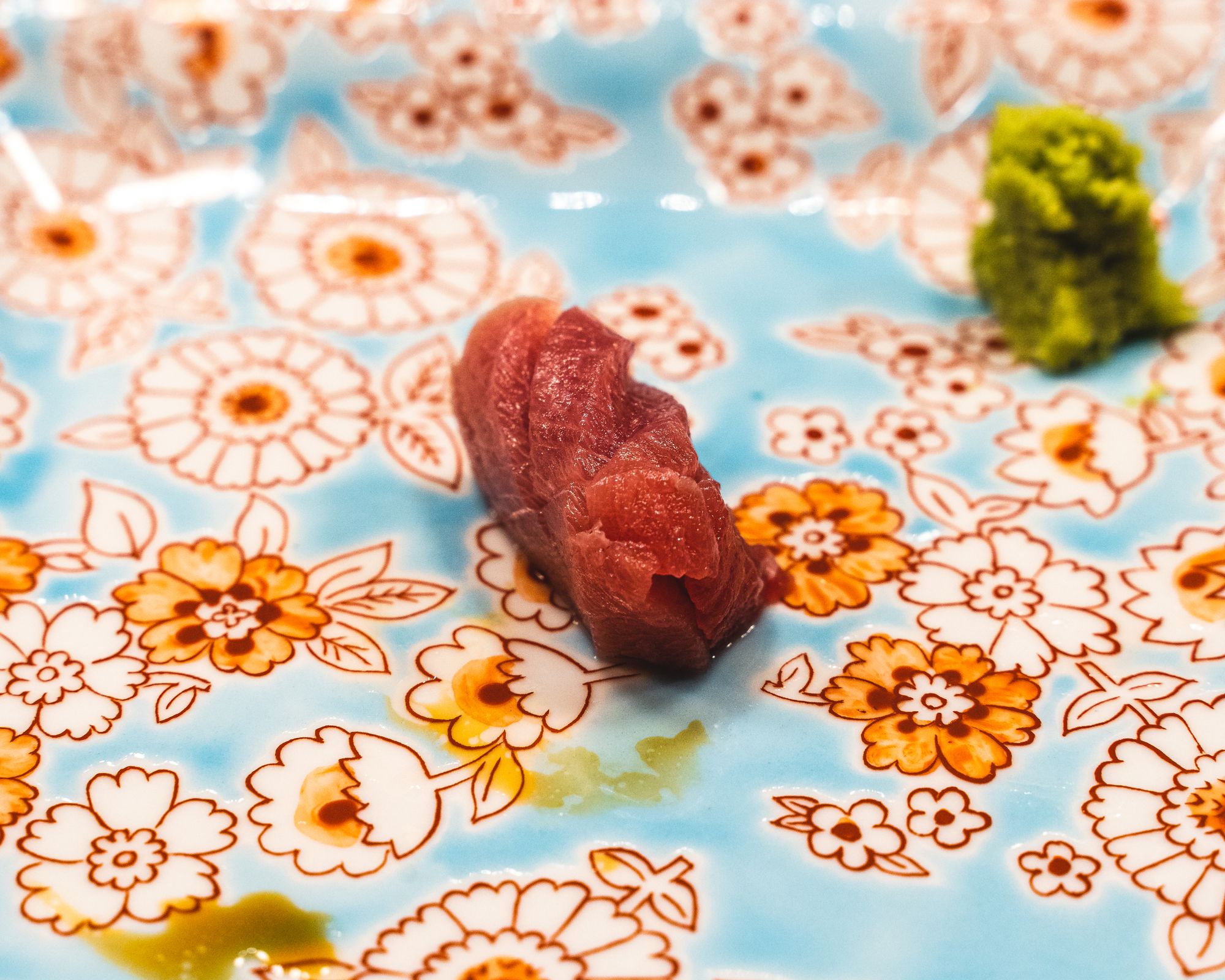 Close up of dry aged toro on a floral plate