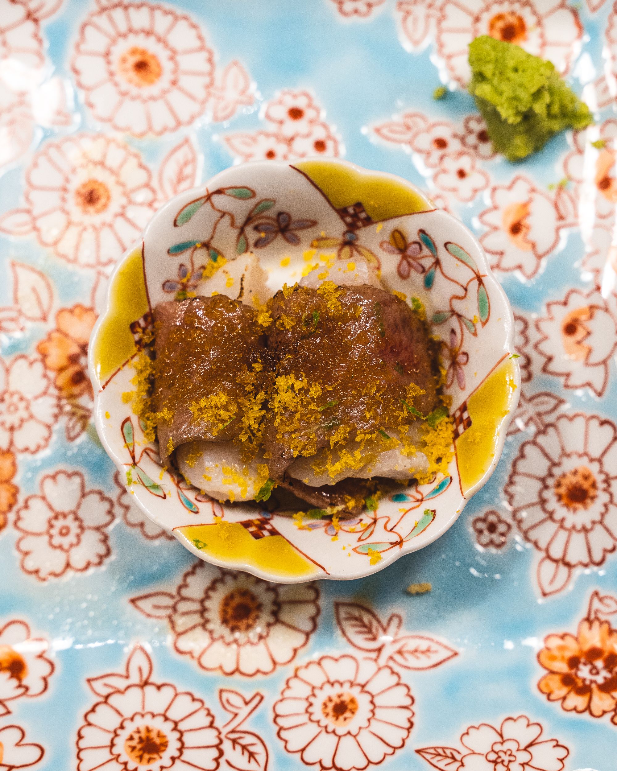 Close up of wagyu wrapped around Japanese scallop with mullet roe on top