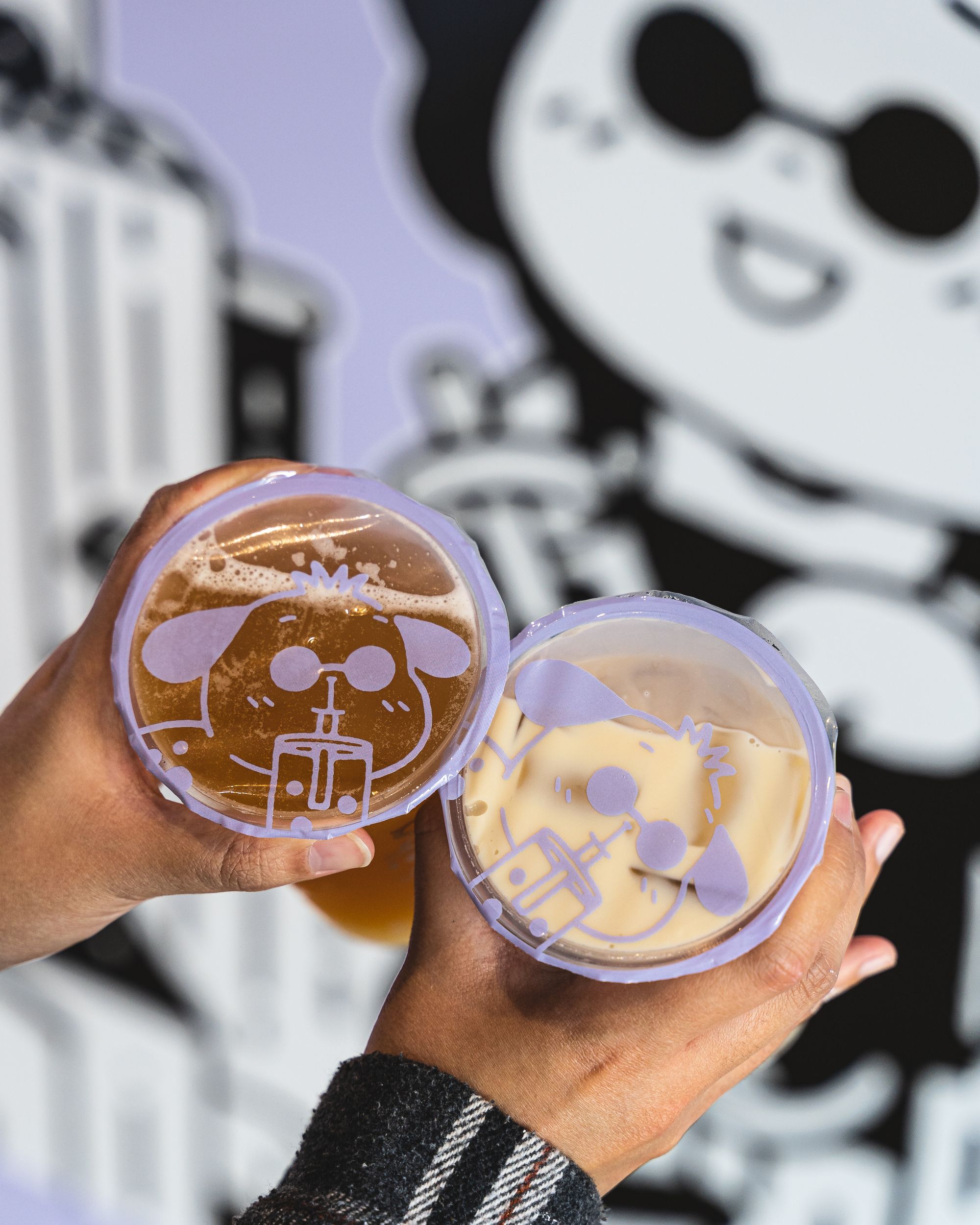 Hand holding two bobas