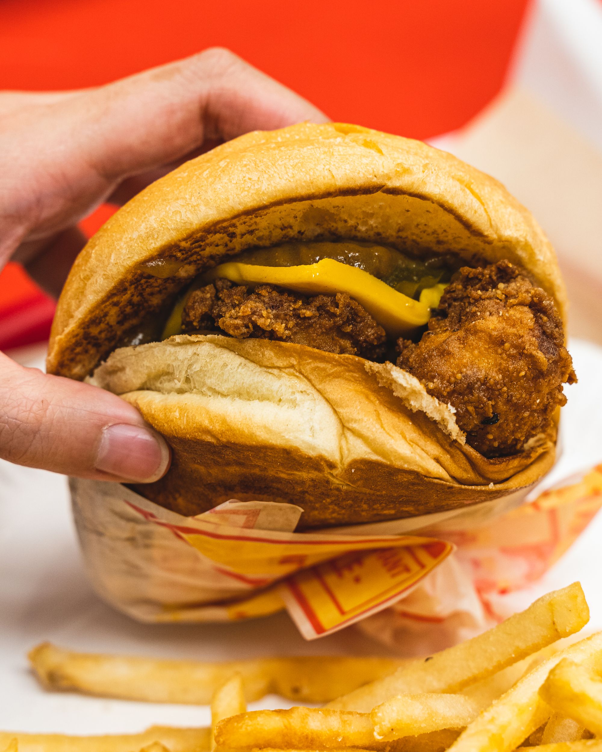 Close up of fried chicken sandwich with cheese and curry sauce