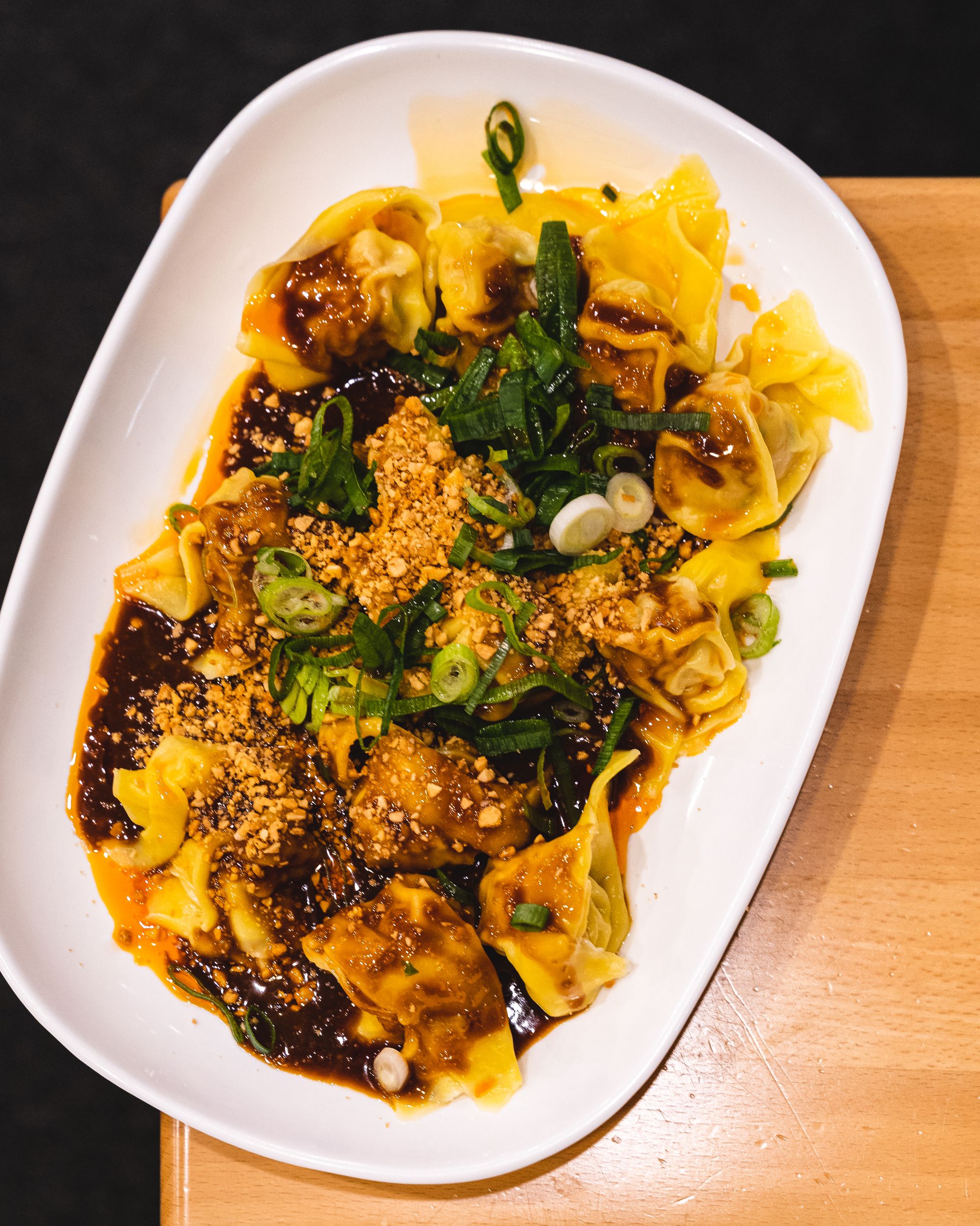 Close up of wontons with chilli sauce