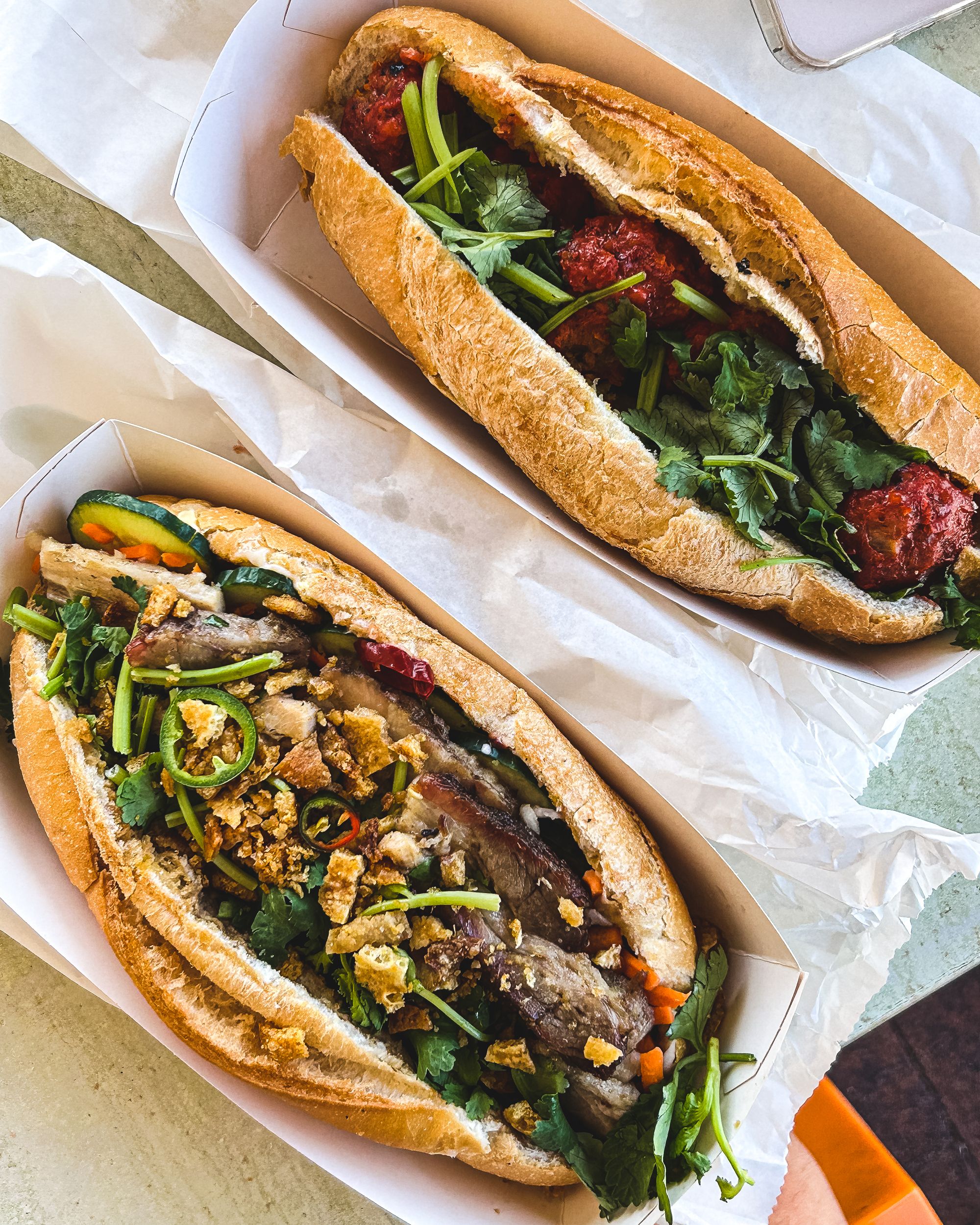 Top down shot of pork belly and pork meatball banh mi