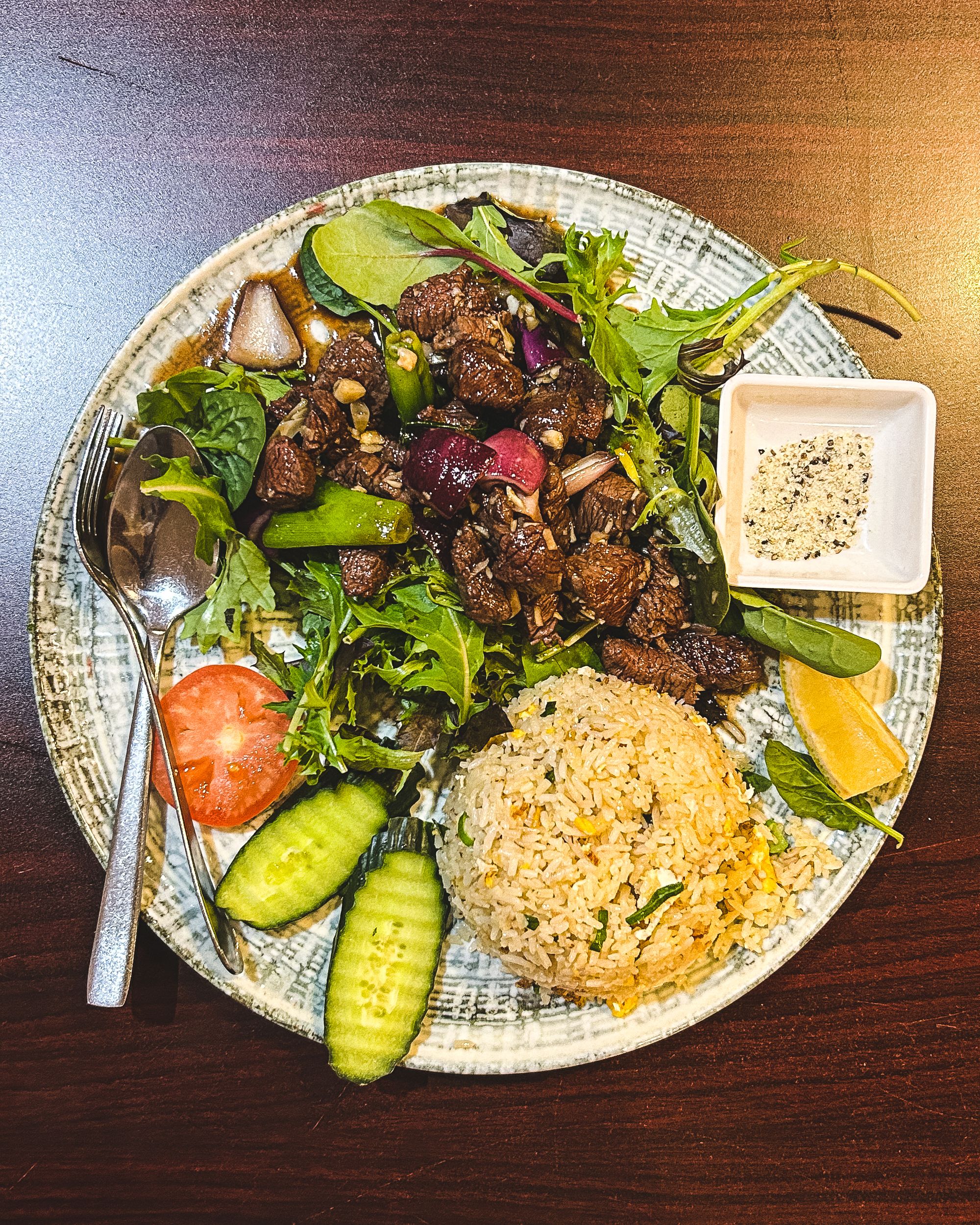Top down of shaking beef with vegetables and fried rice
