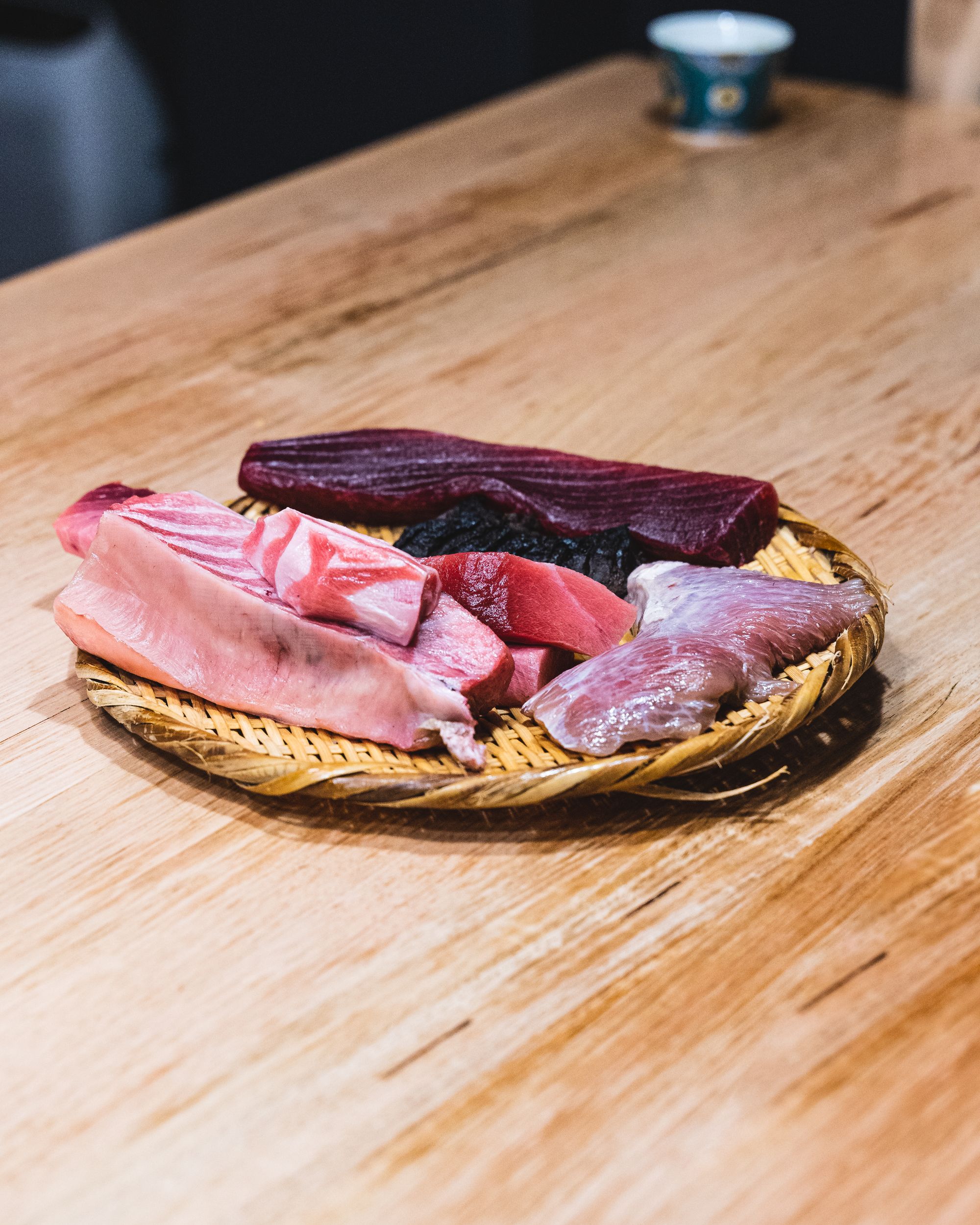 A rattan basket with different cuts of tuna