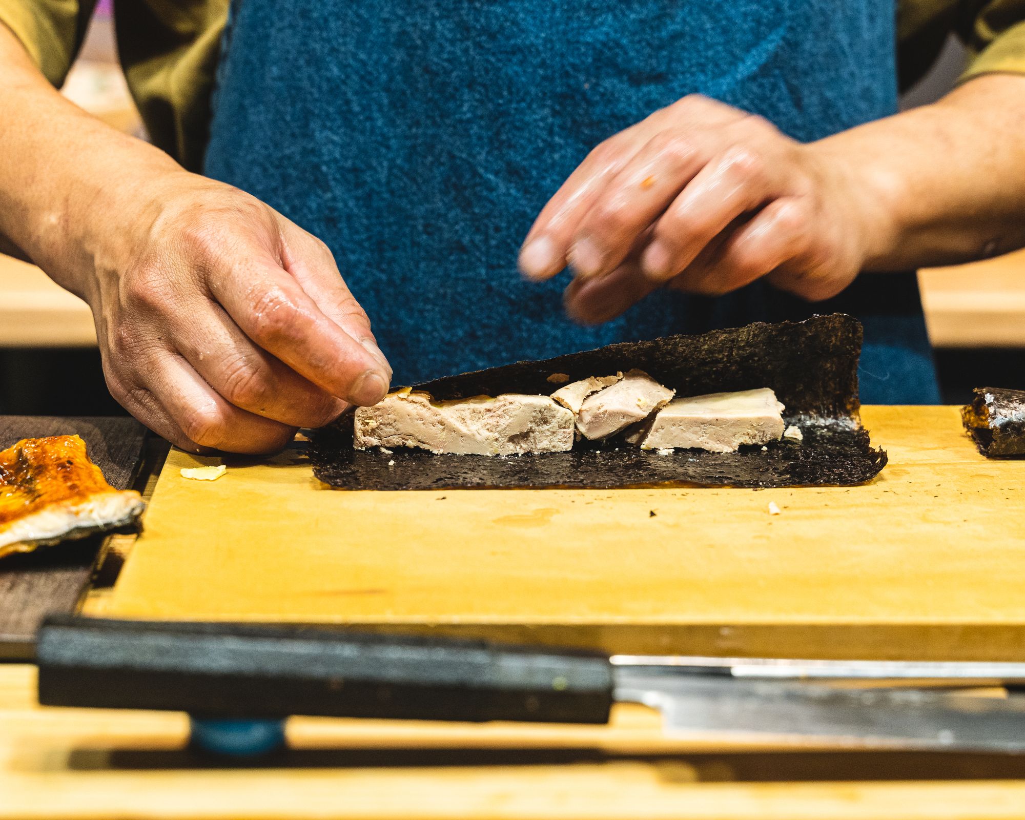 Chef rolling foie gras into seaweed
