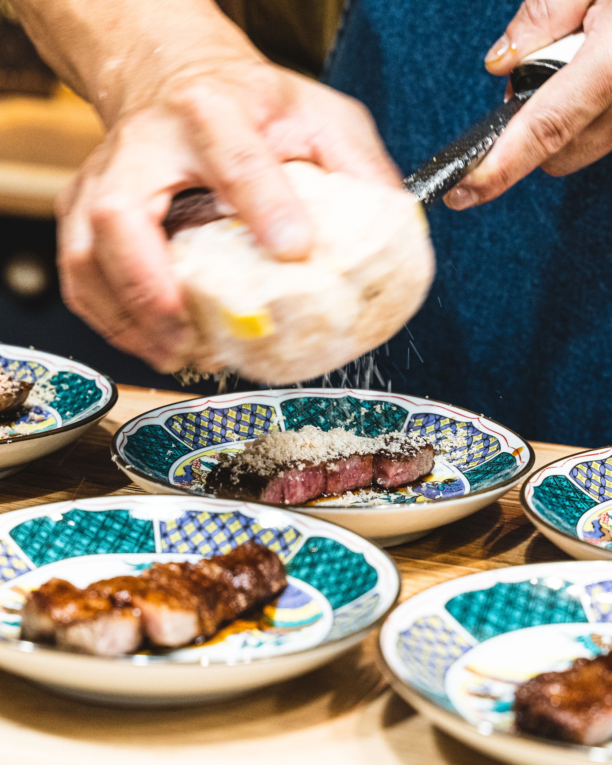 Close up of foie gras being shaved onto wagyu