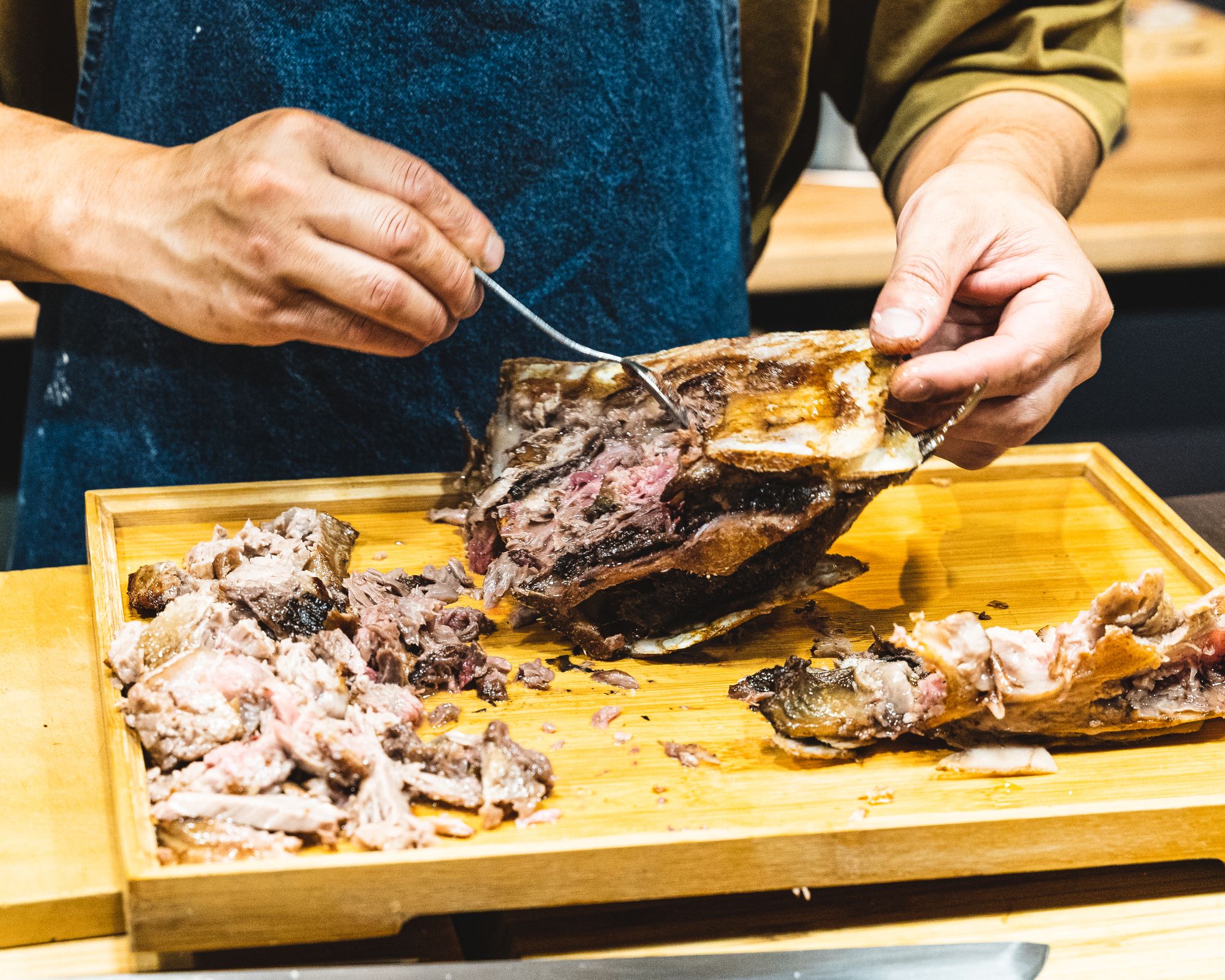 Chef carving out tuna collar meat