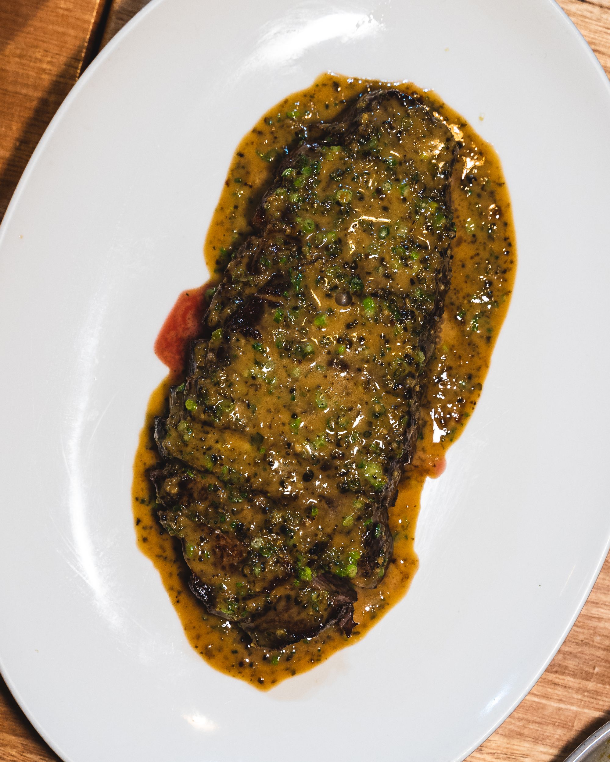 Top down shot of beef steak with peppercorn sauce