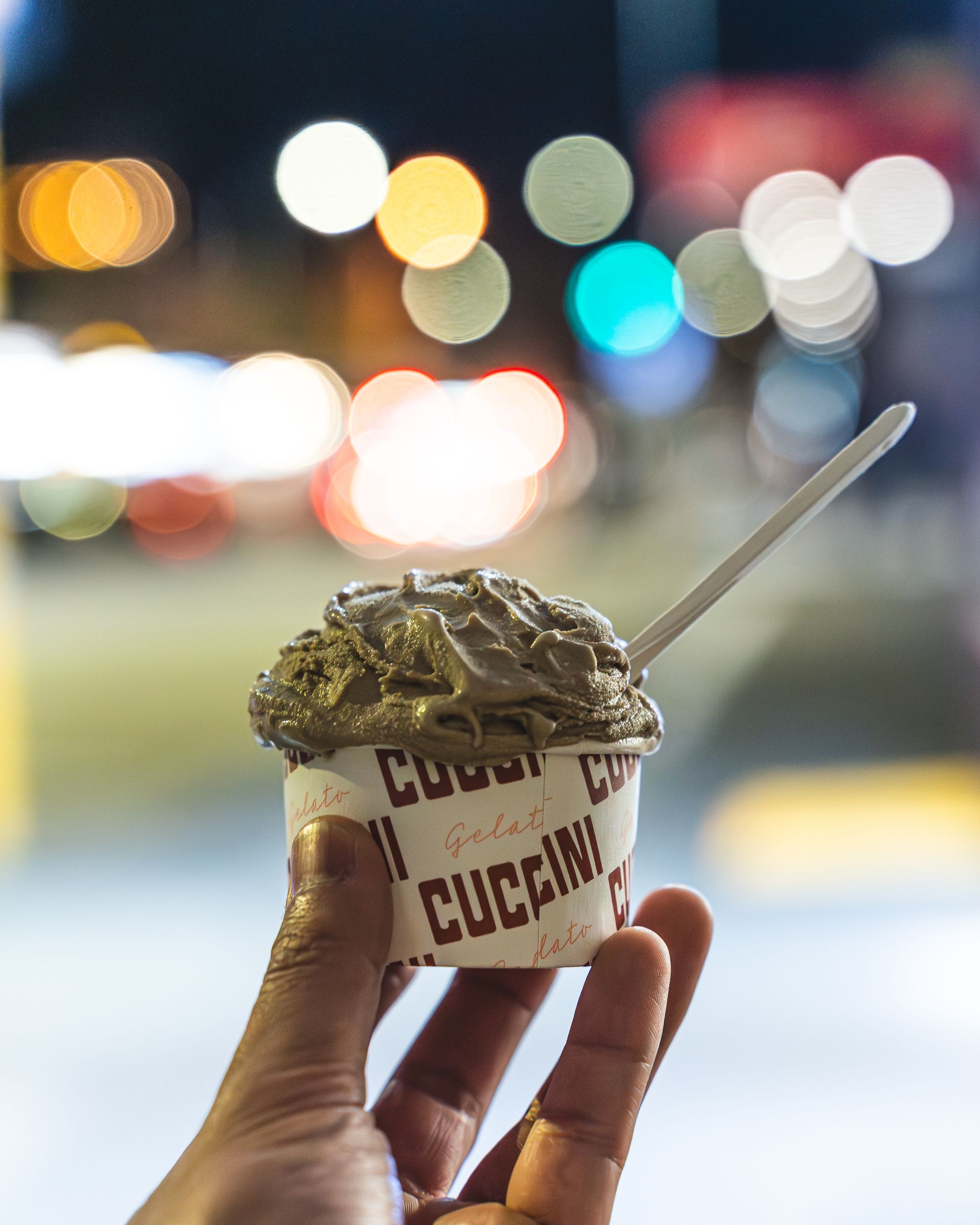 Hand holding up a cup of gelato