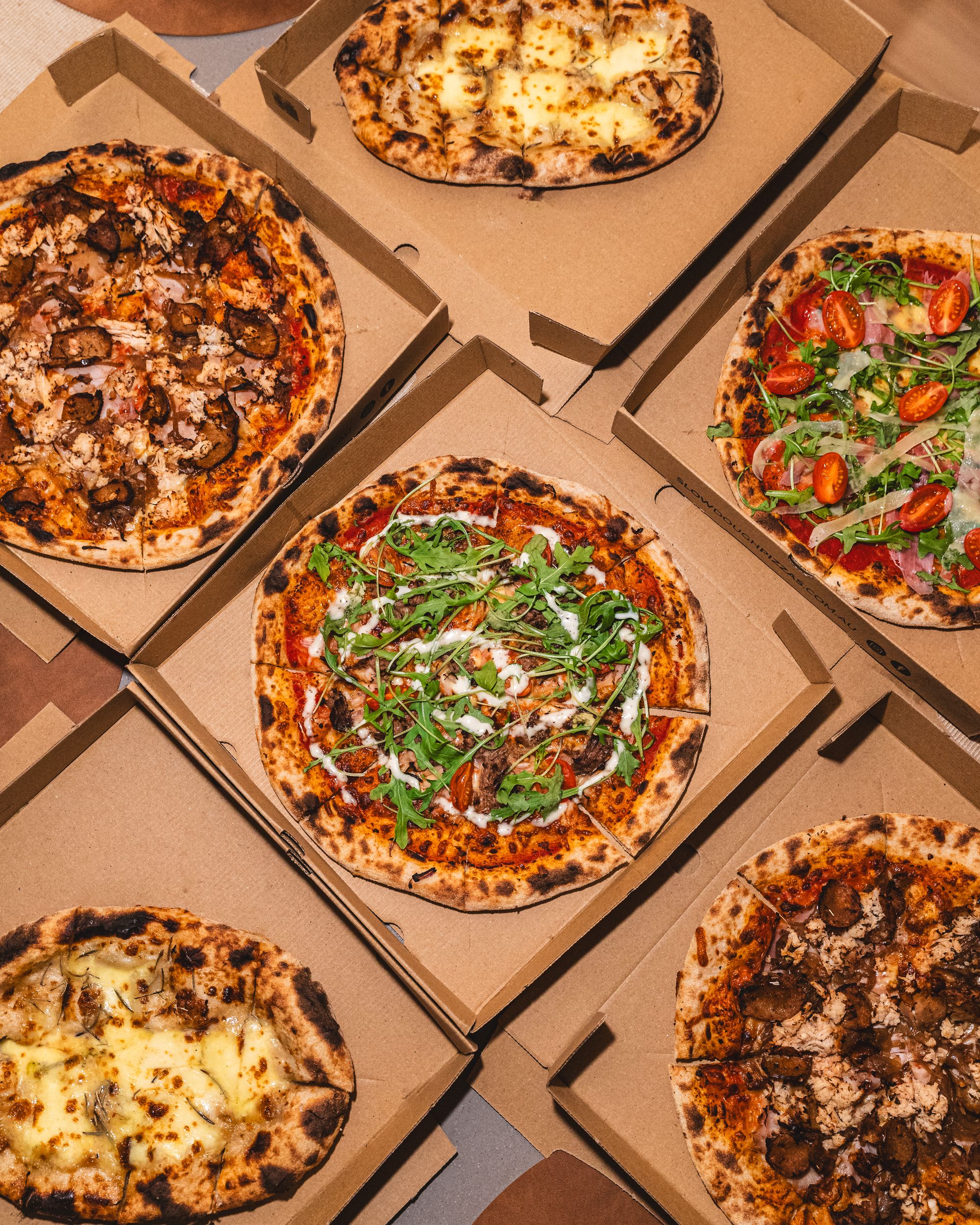 Top down shot of 5 different sourdough pizzas