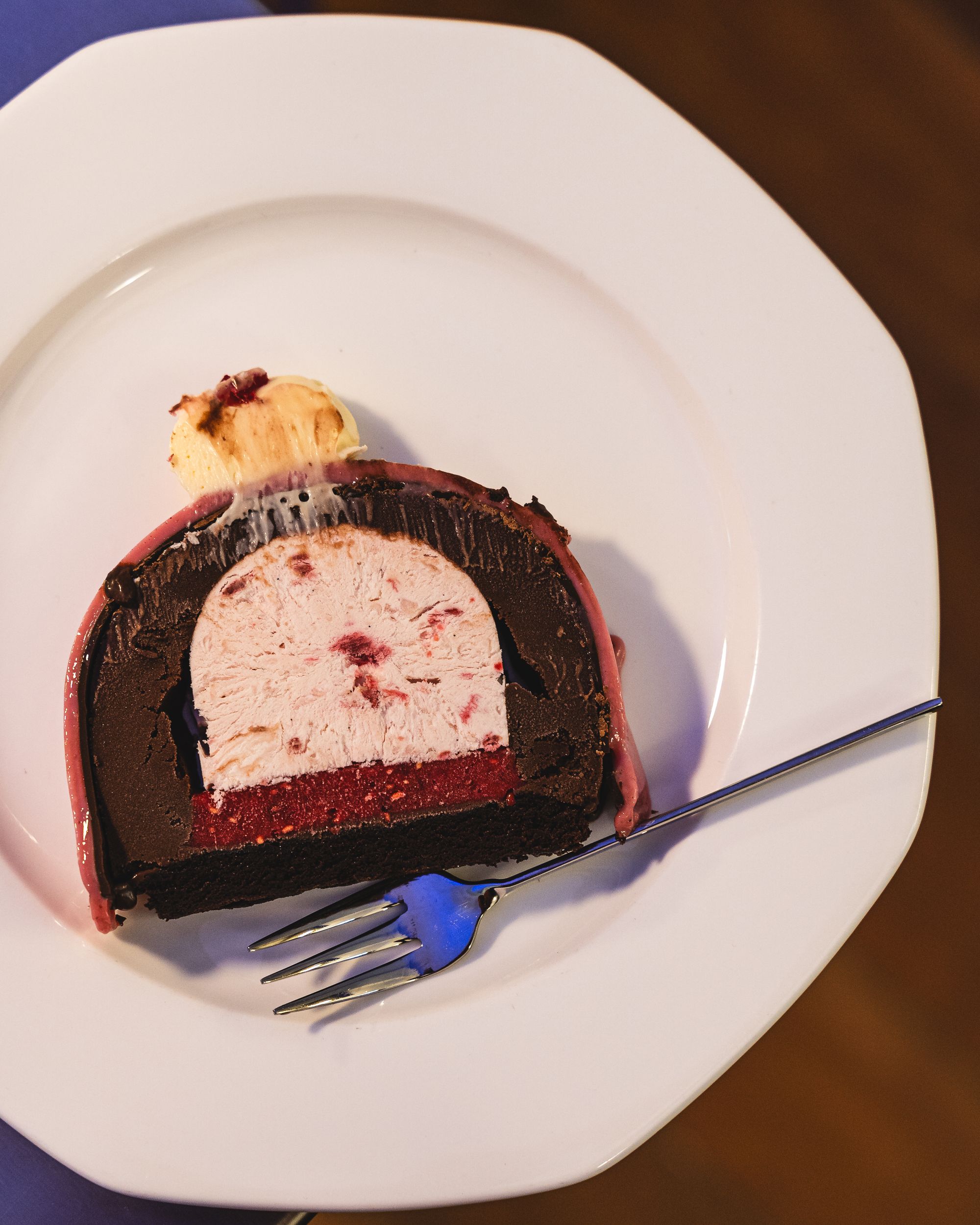 Slice of ice-crema cake with emifroddo, dark chocolate gelato and white chocolate ganache