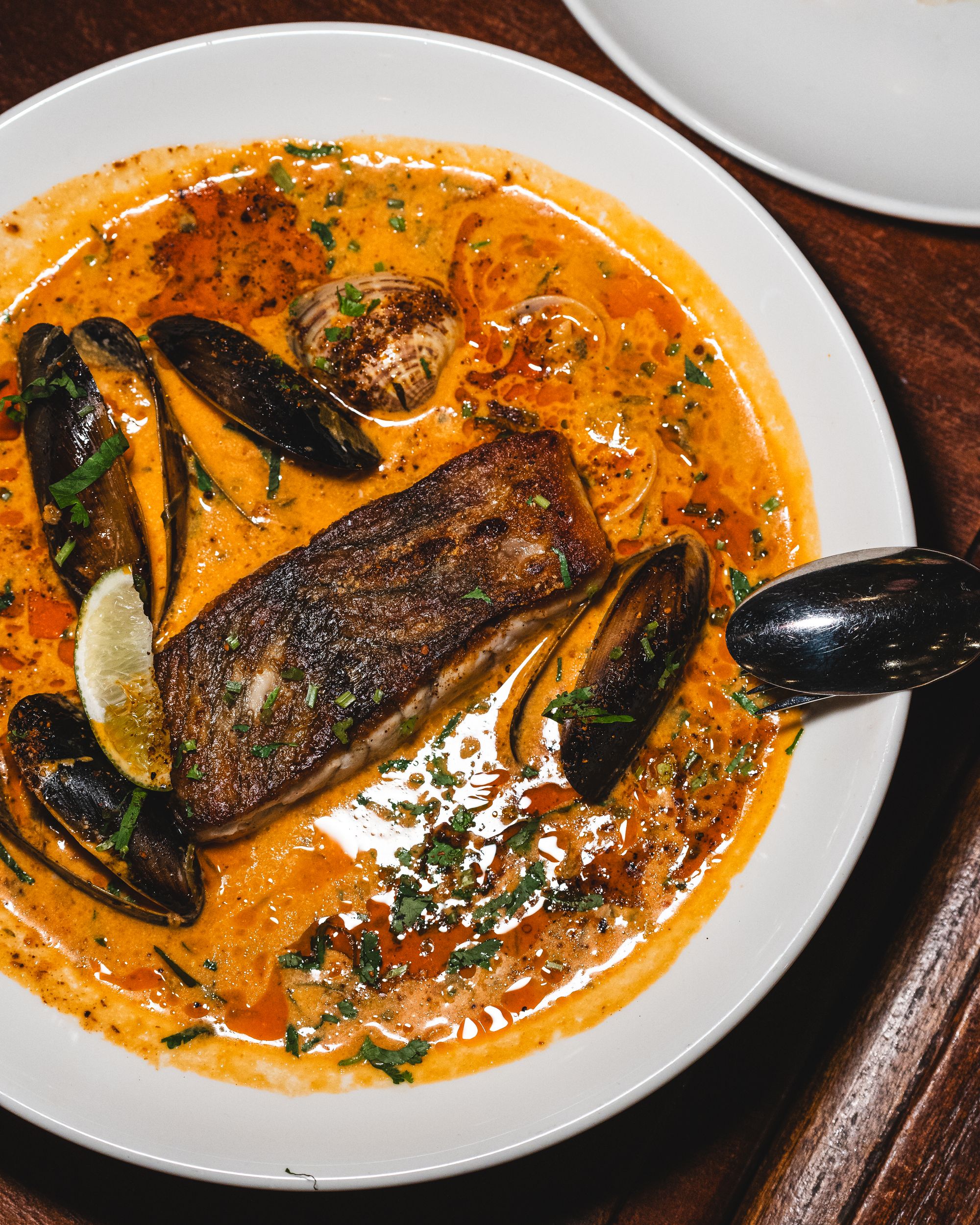 Top down shot of barramundi in coconut sauce