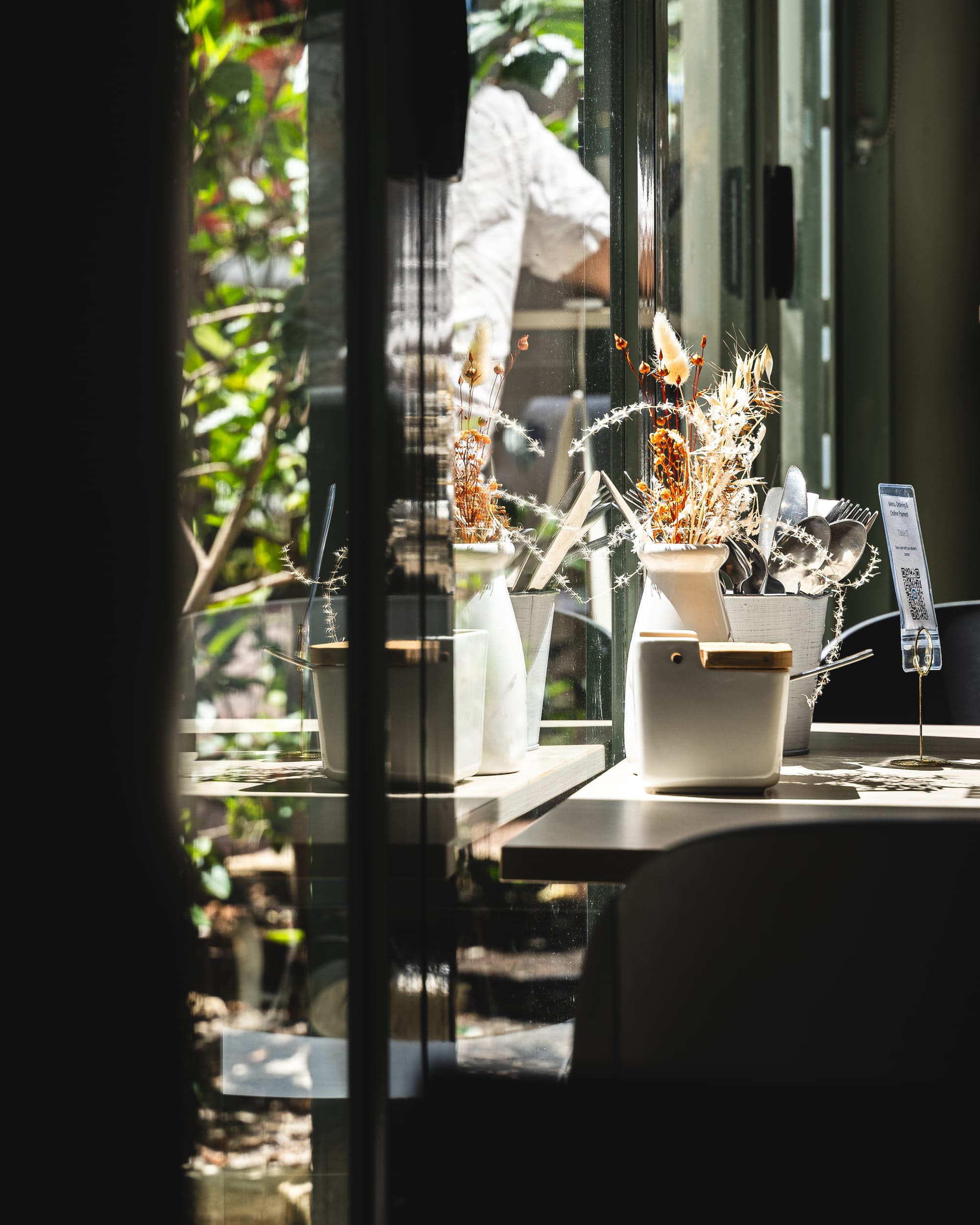 Photo of flowers on a table up against French doors