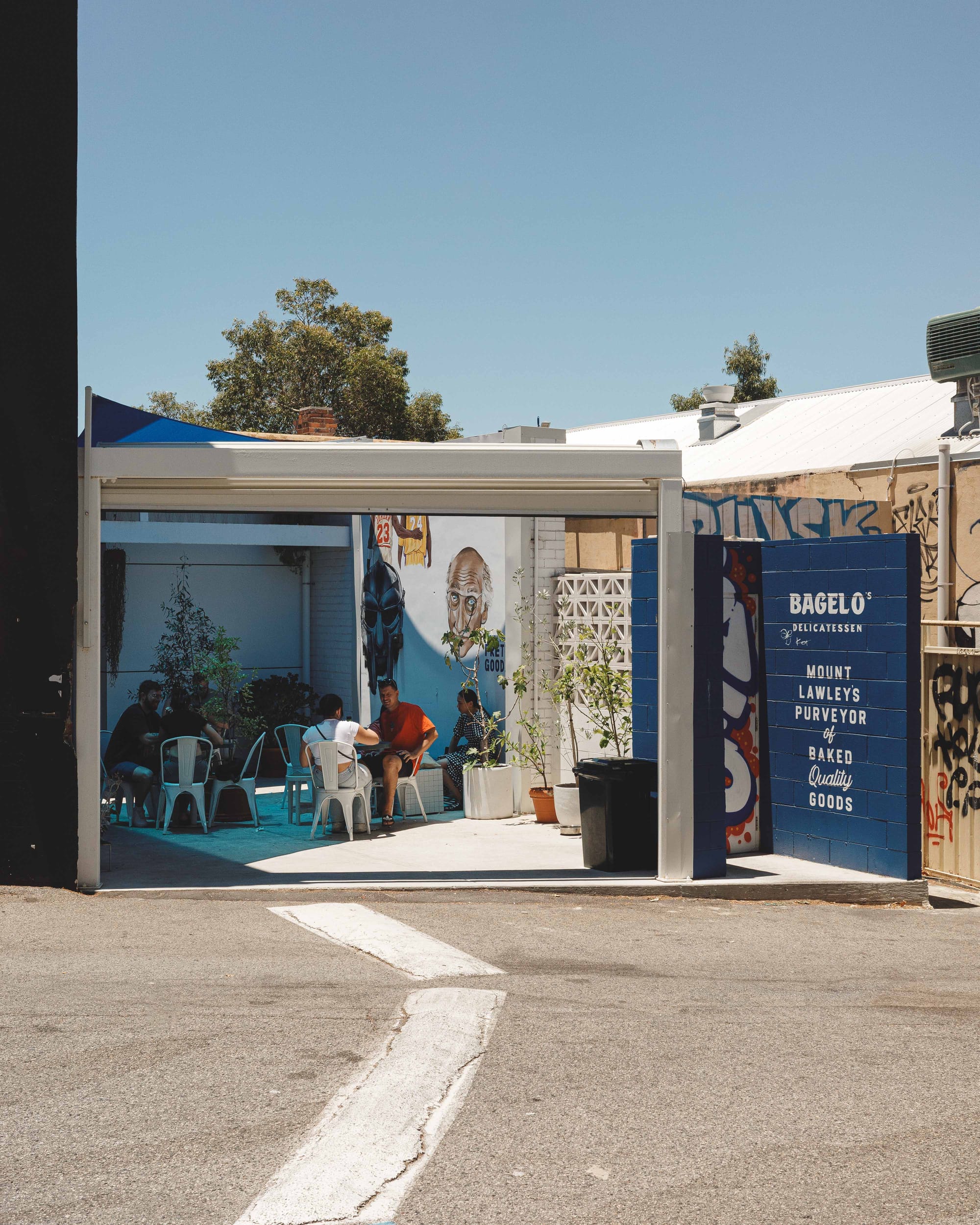 Daytime shot of Bagel O Delicatessen showing their outdoors seating area