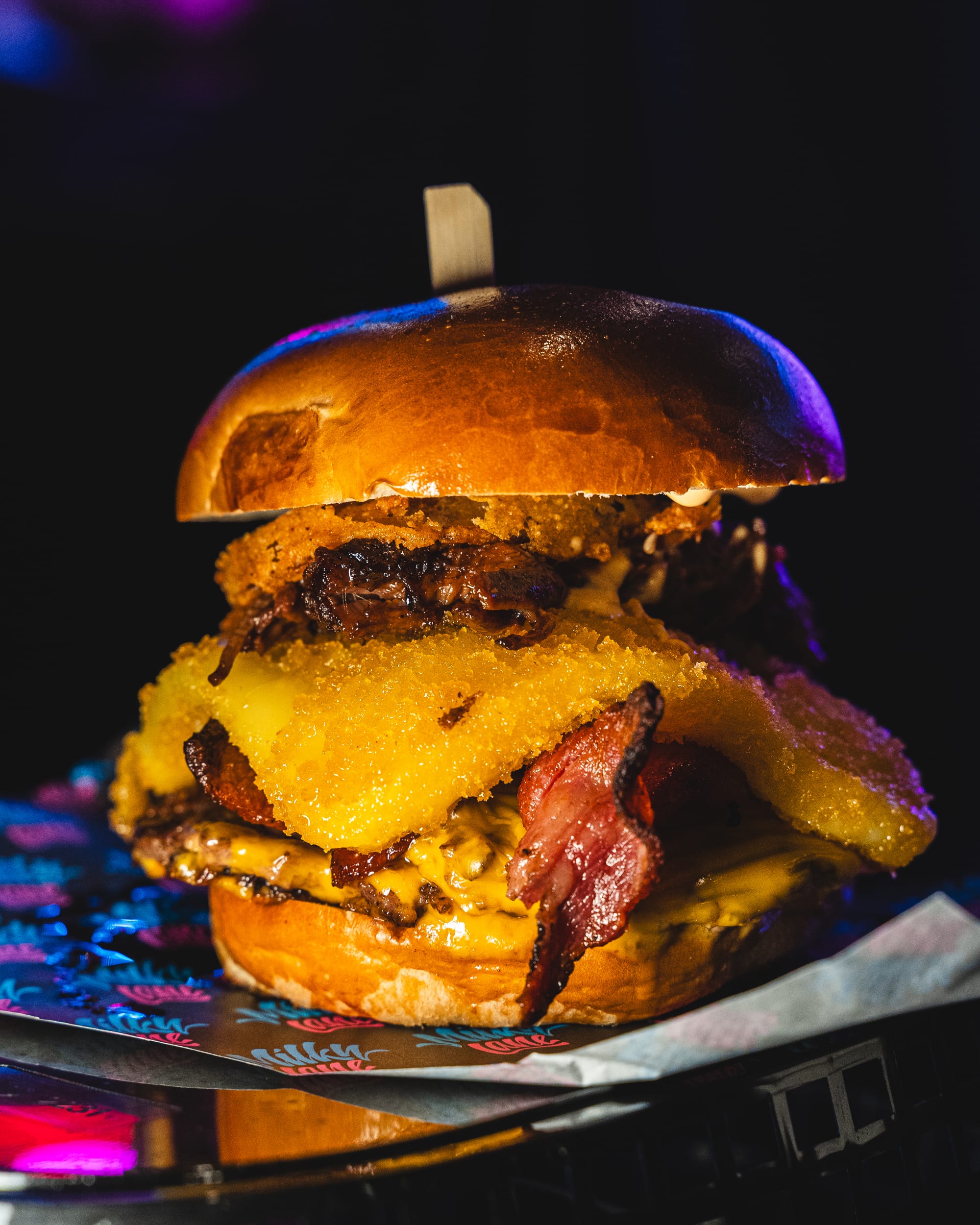 Close up of burger with cheese, smashed pattie and onions