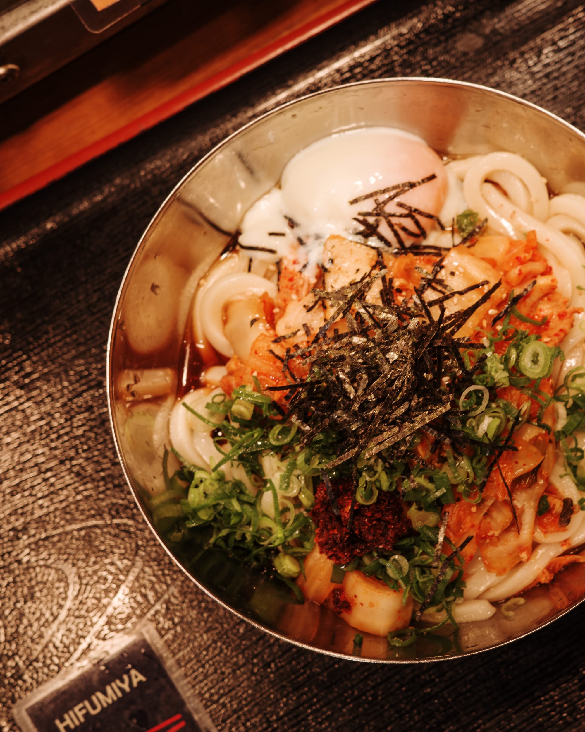 Close up top down shot of udon showing shredded seaweed