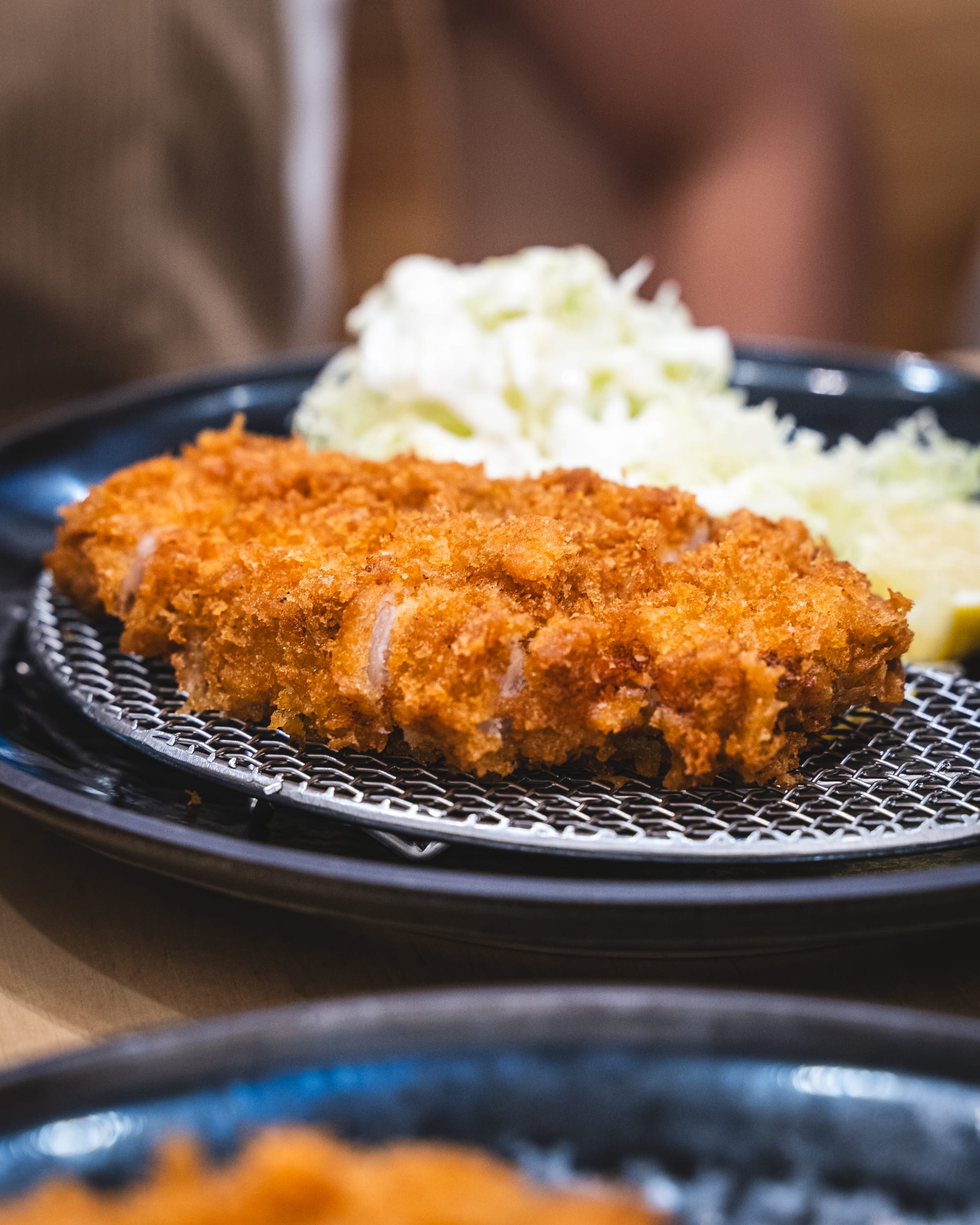 Close up of pork katsu with a pile of cabbage
