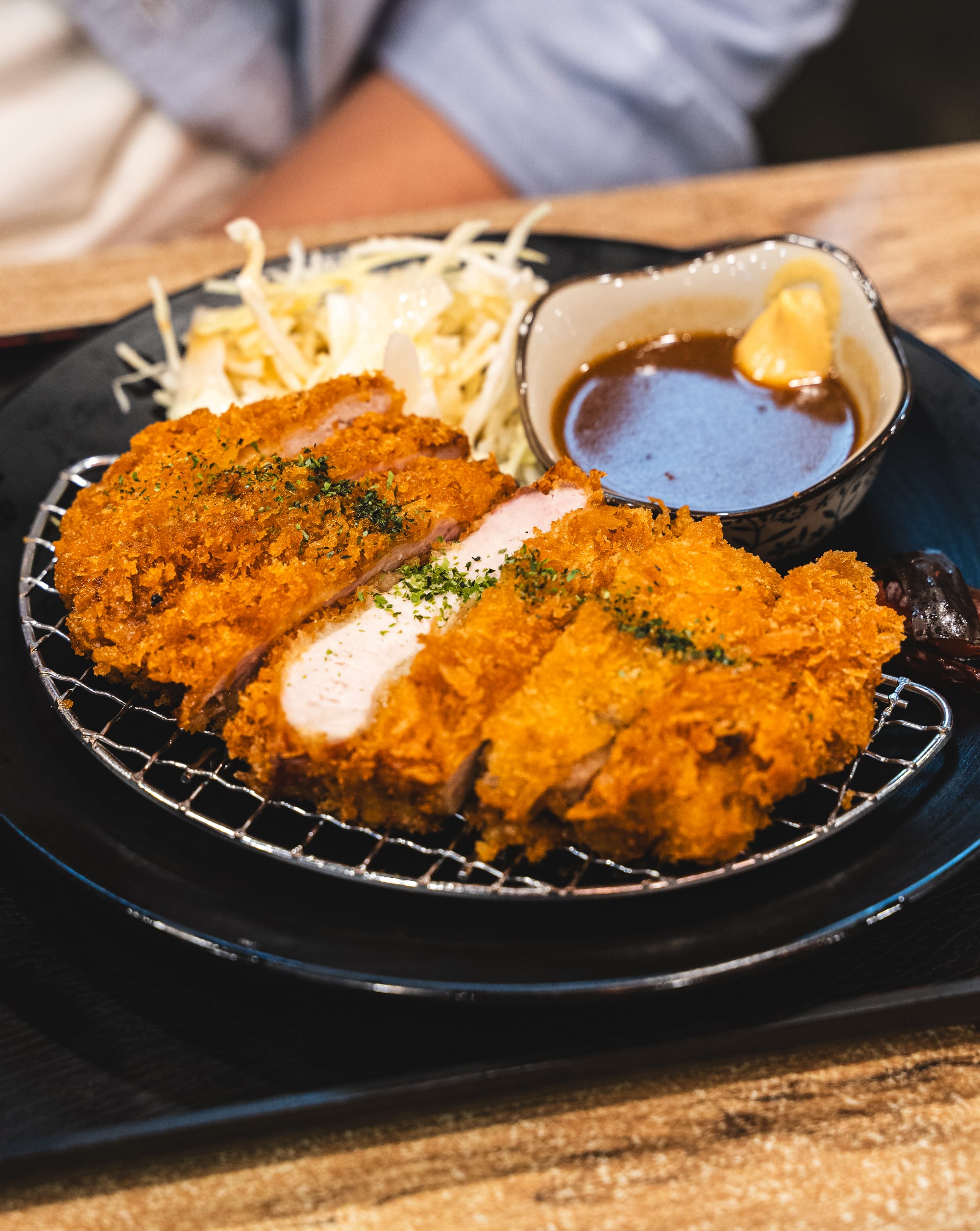 Close up of tonkatsu with cabbage salad and katsu sauce