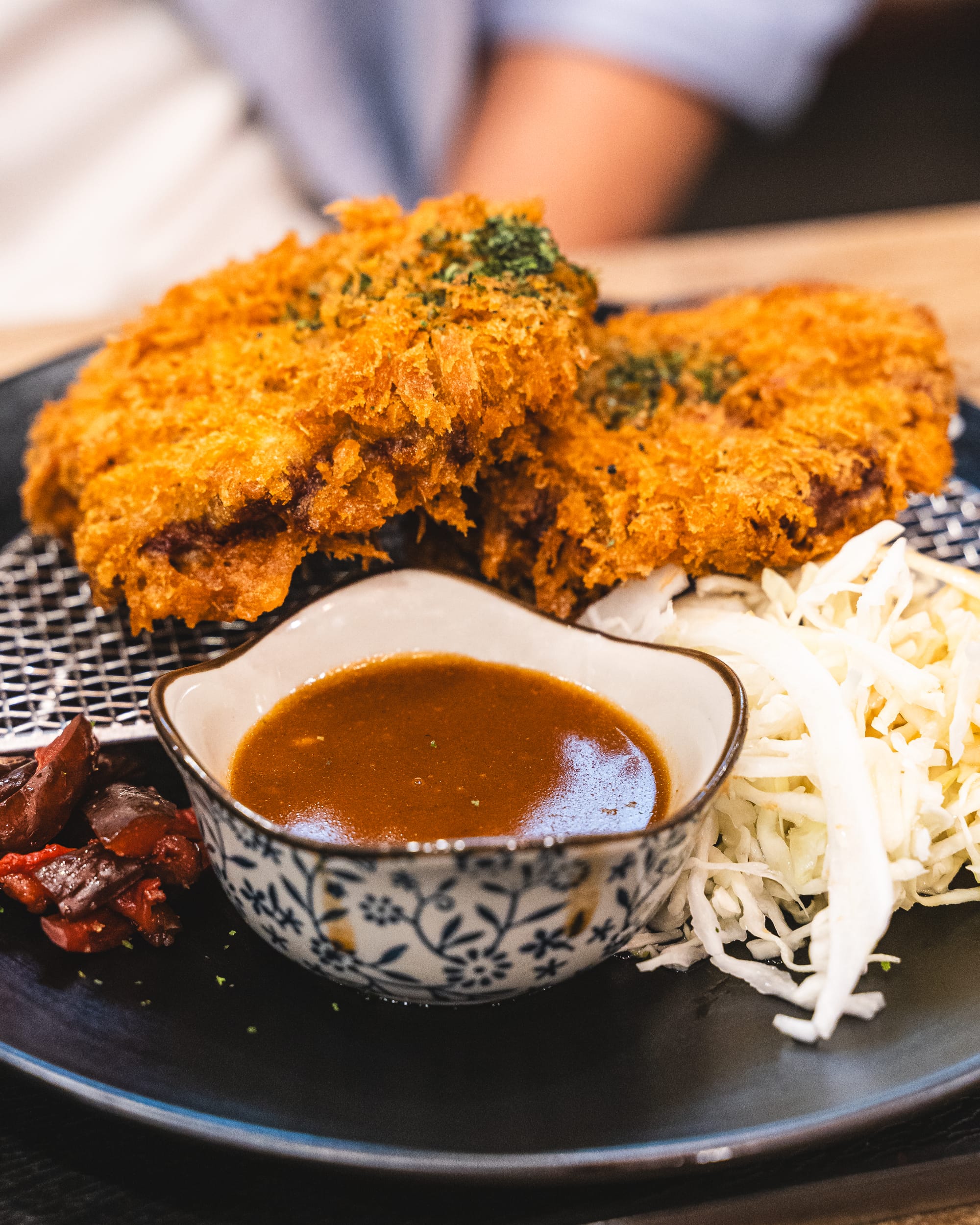 Close up of minced beef katsu with katsu sauce and cabbage salad