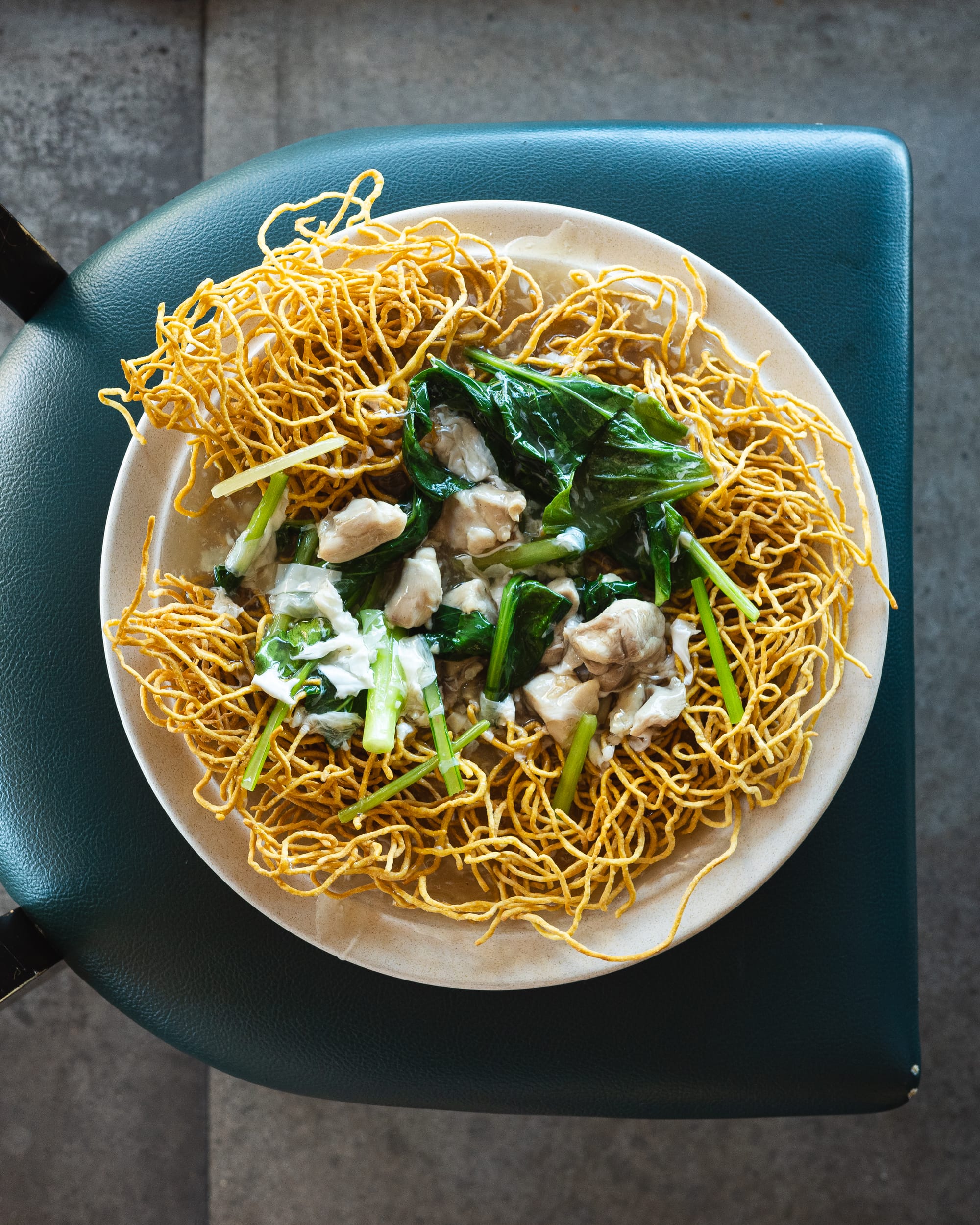Top down shot showing fried noodles with vegetables and chicken