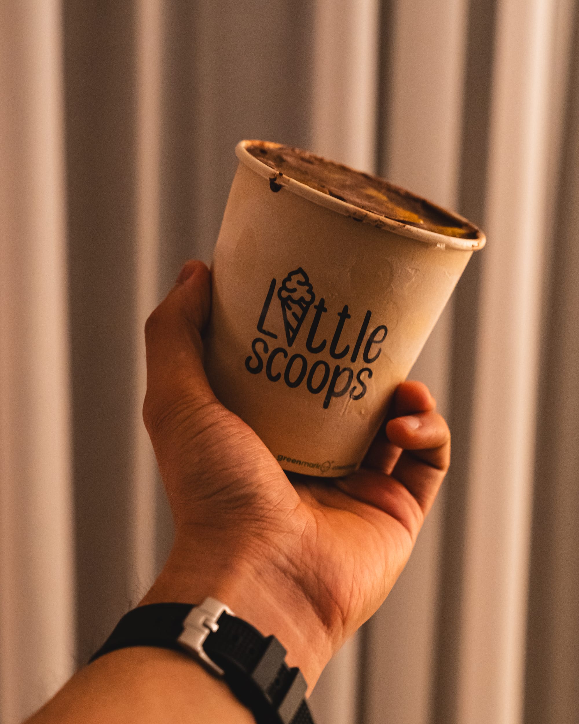 Hand holding a cup of ice-cream