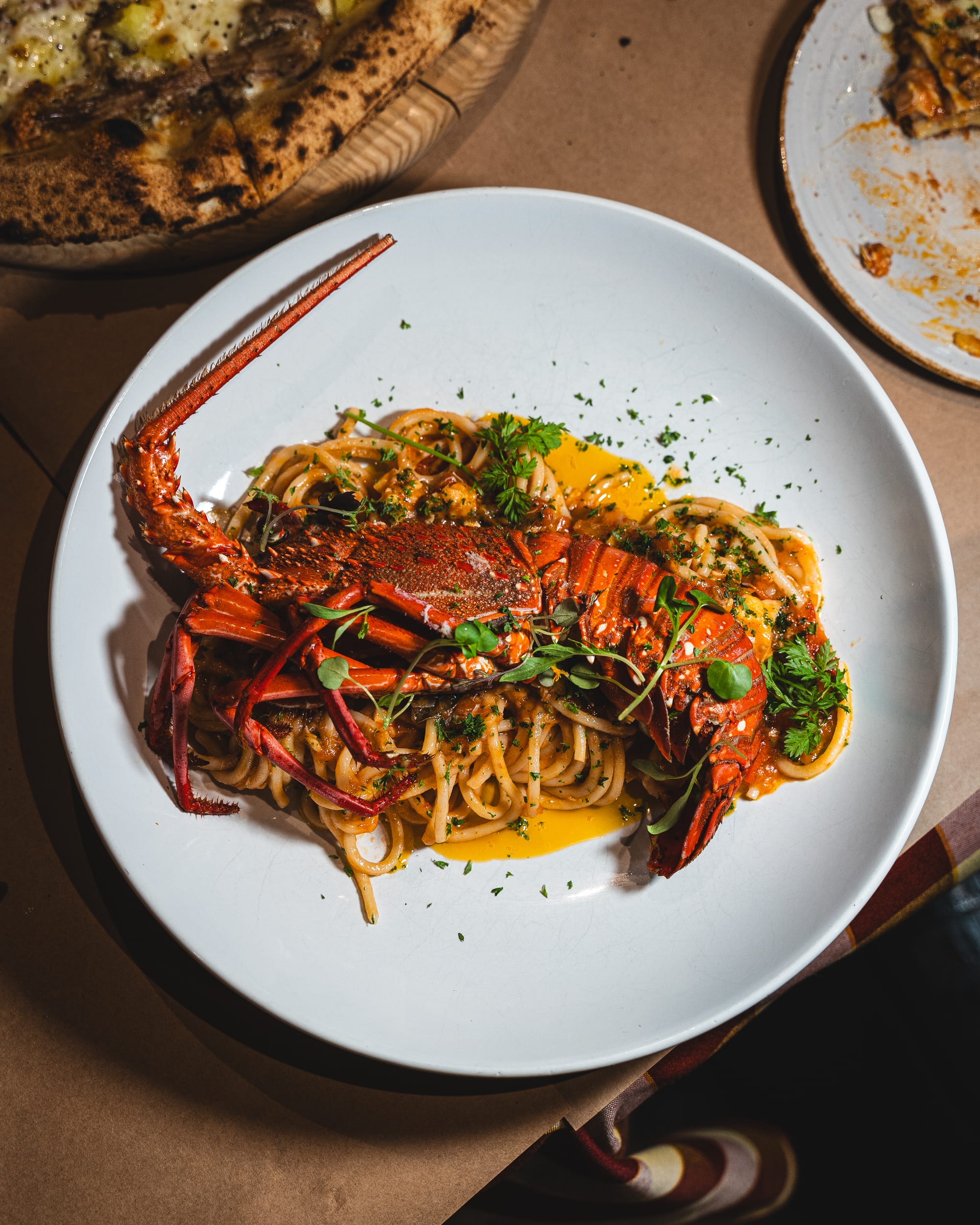 Spaghetti Lobster $42 - cooked in a light cherry tomato sauce, hint of chilli, Italian herbs, served with Β½ lobster (250g-300g)
