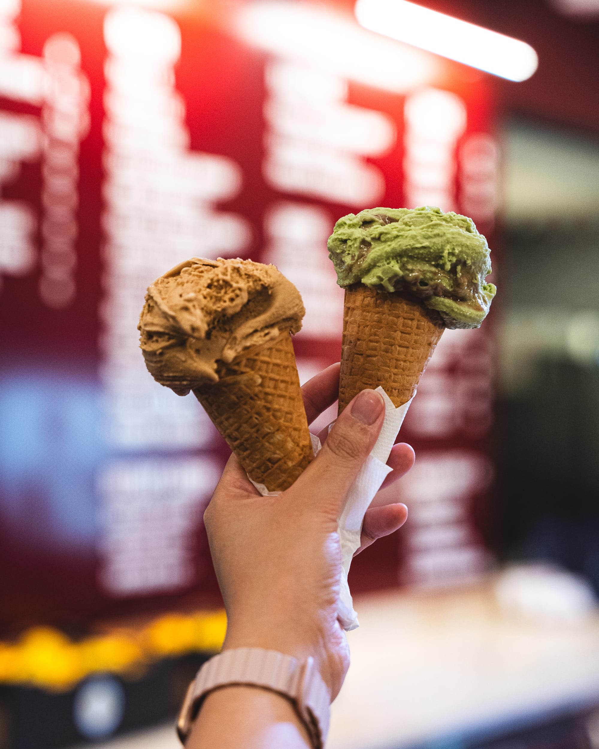 Hand holding two ice-cream cones