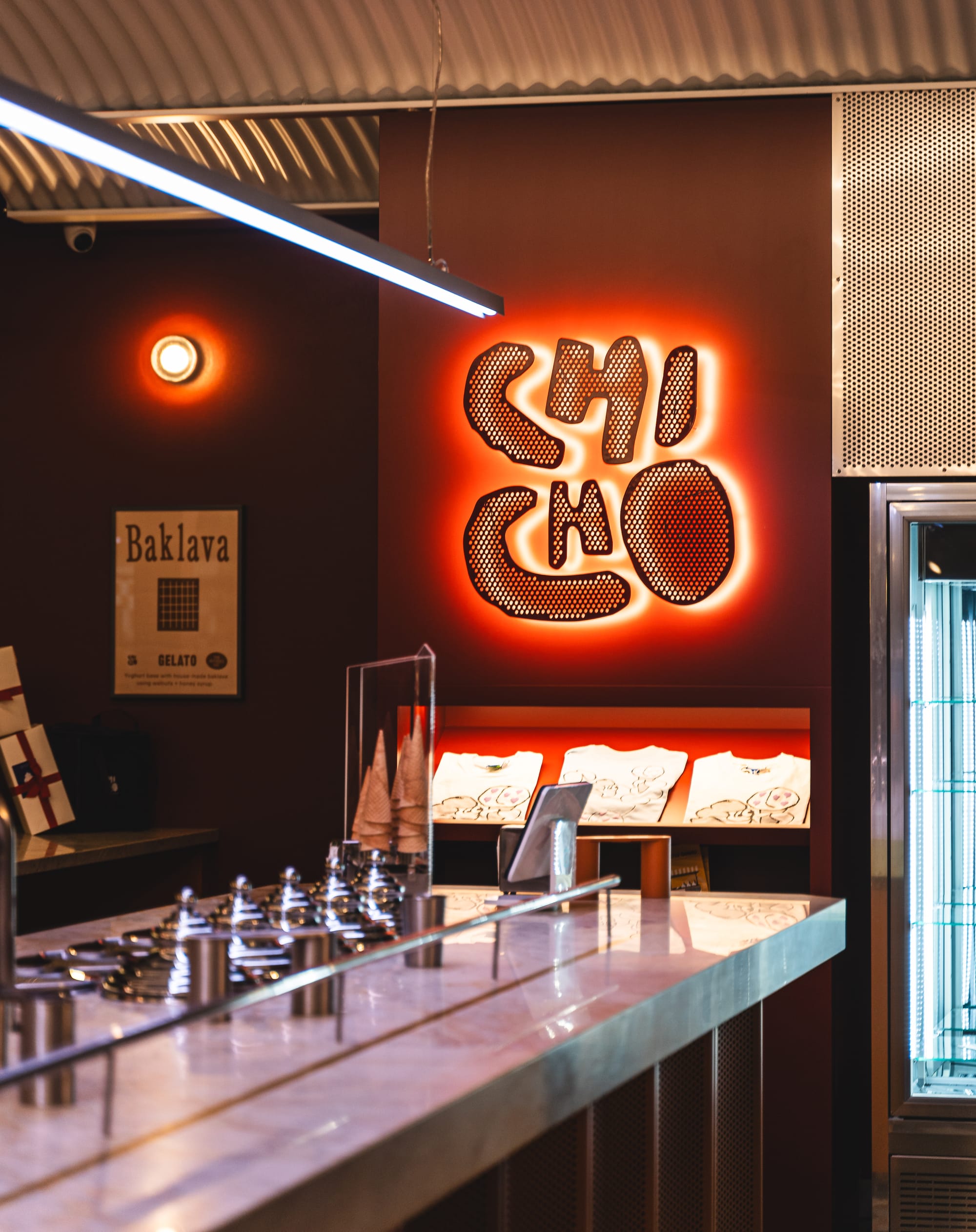 Interior shot of Chicho Gelato showing a Chicho sign on the wall