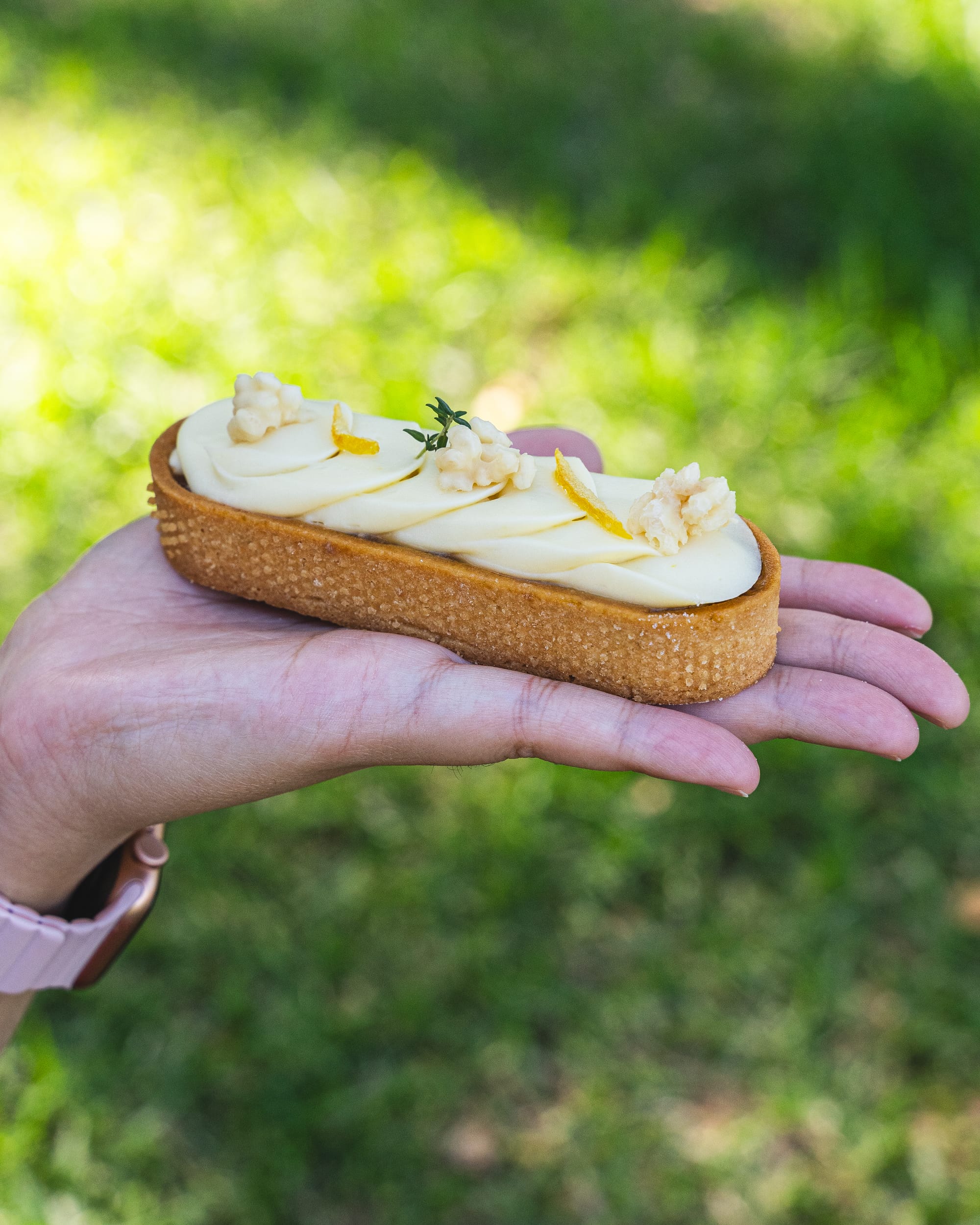 Hand holding pastry tart