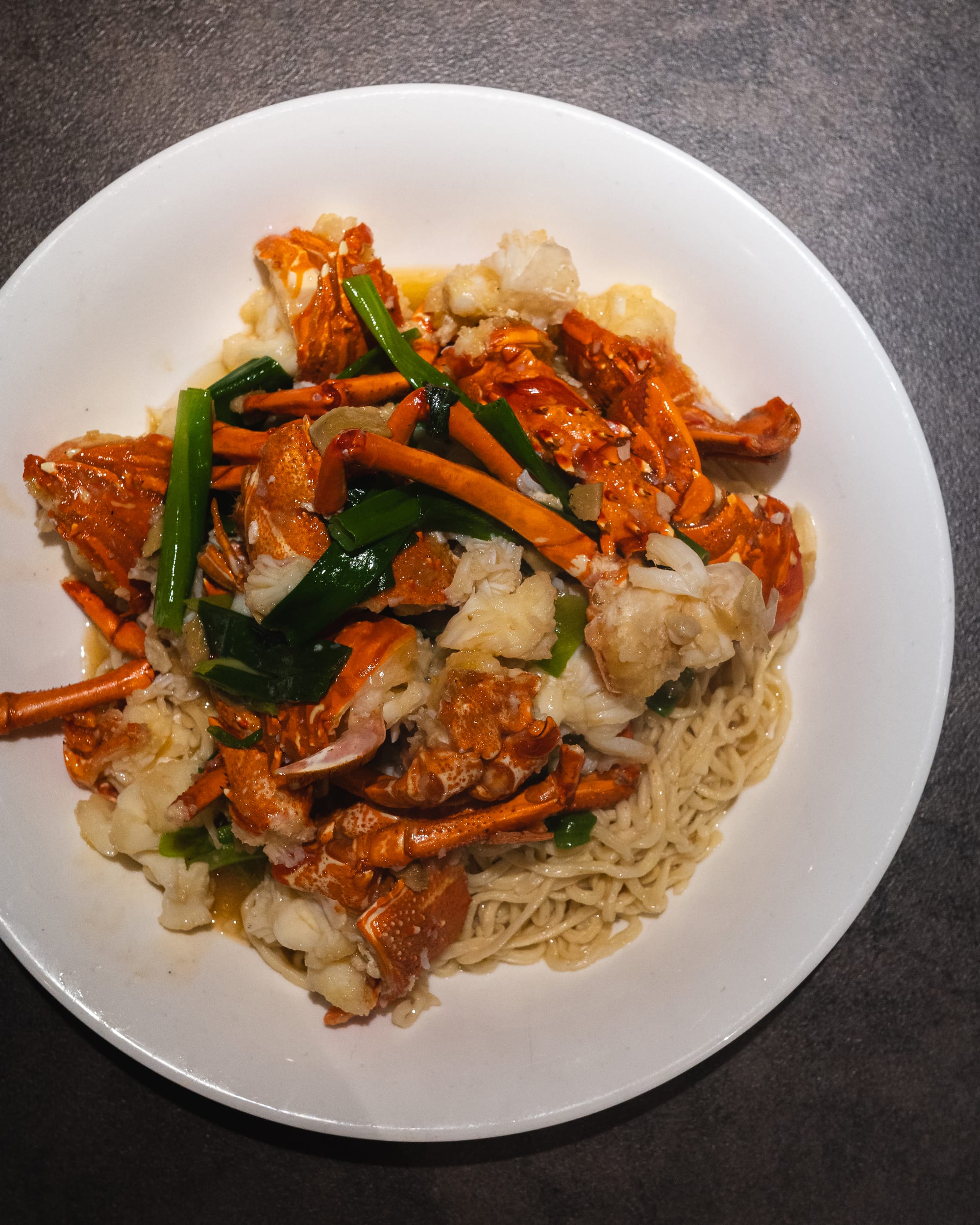 Top down shot of lobster with yee mien noodles