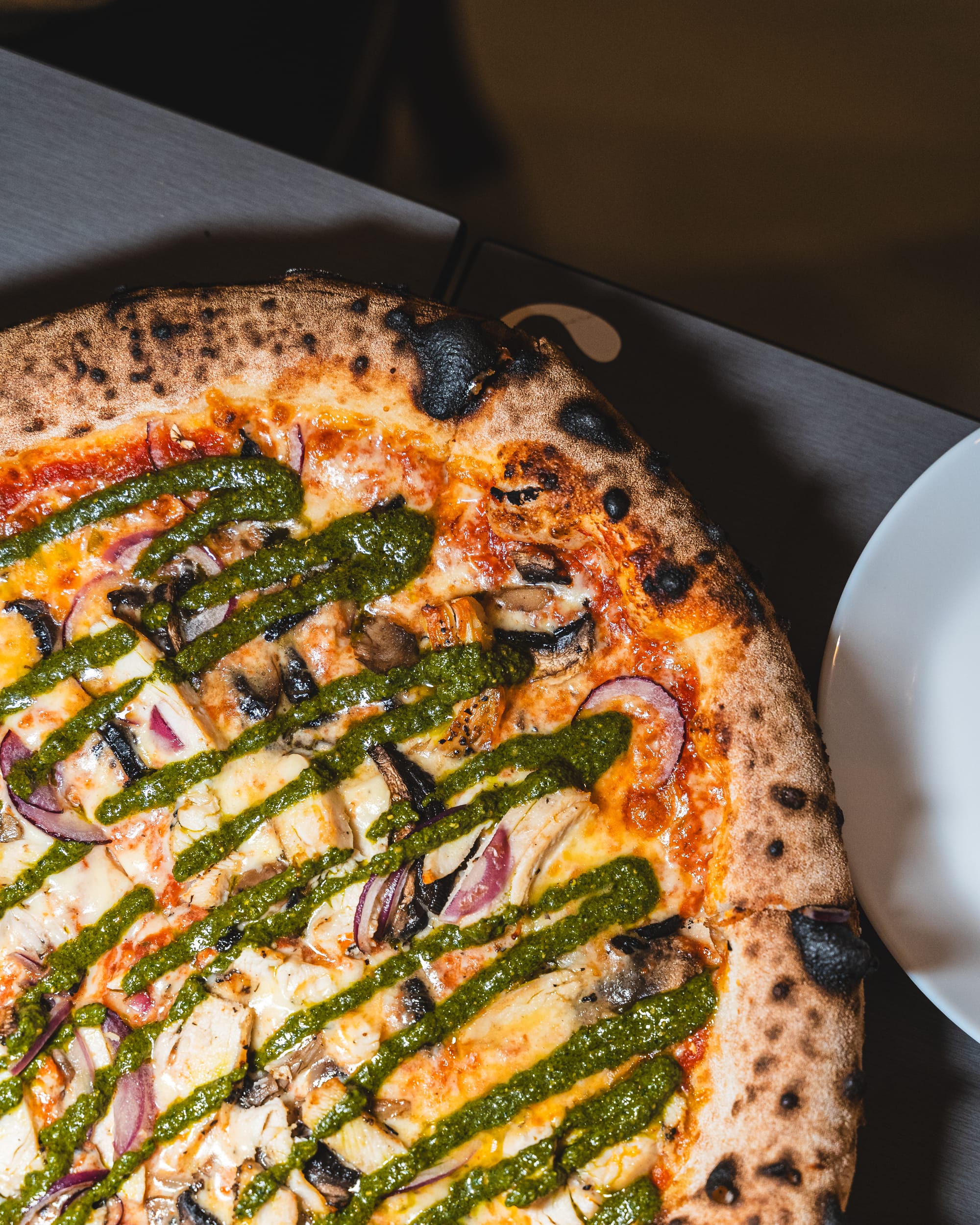 Top down shot of pizza with pesto