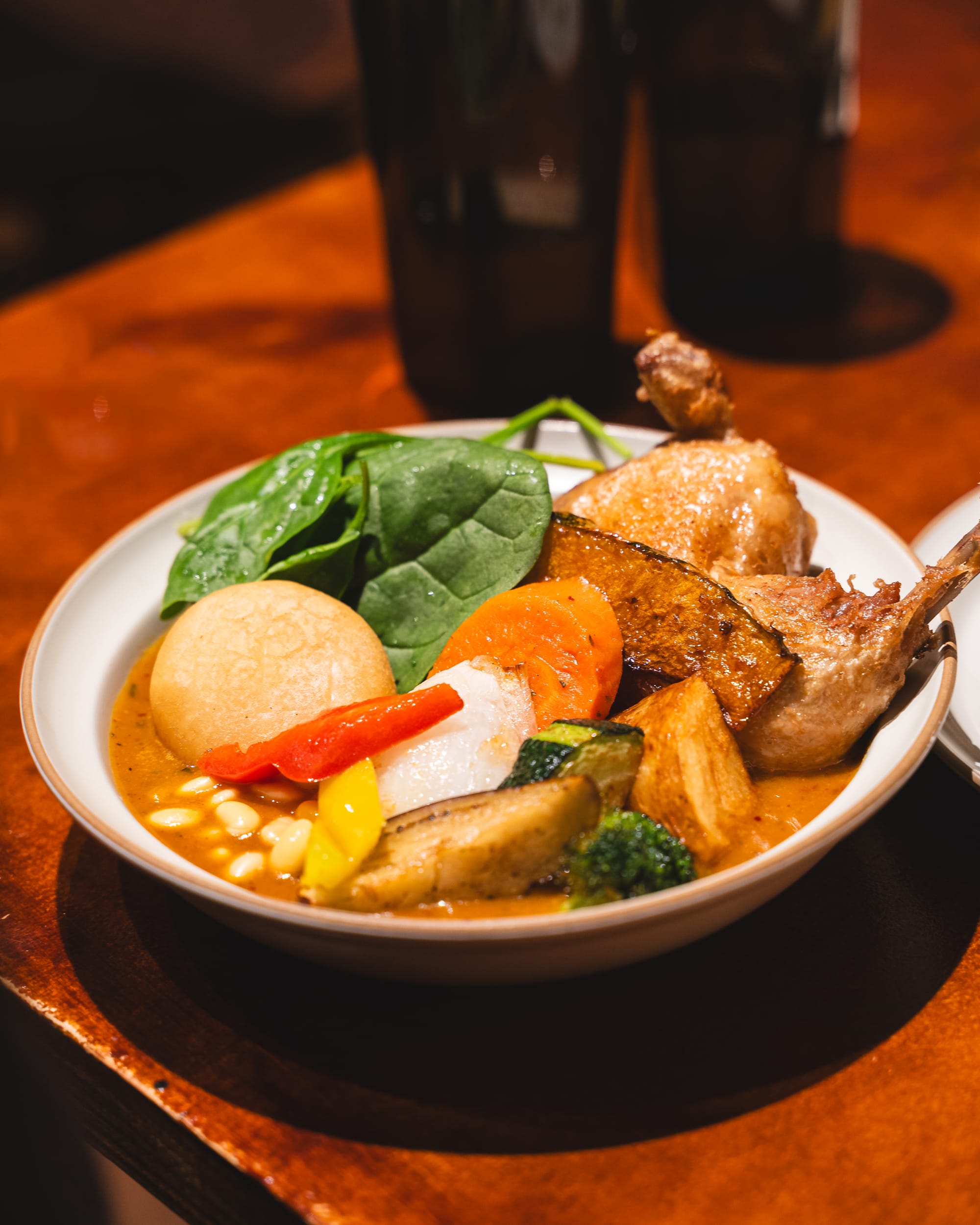 Close up of soup curry with fried chicken Maryland and assorted vegetables