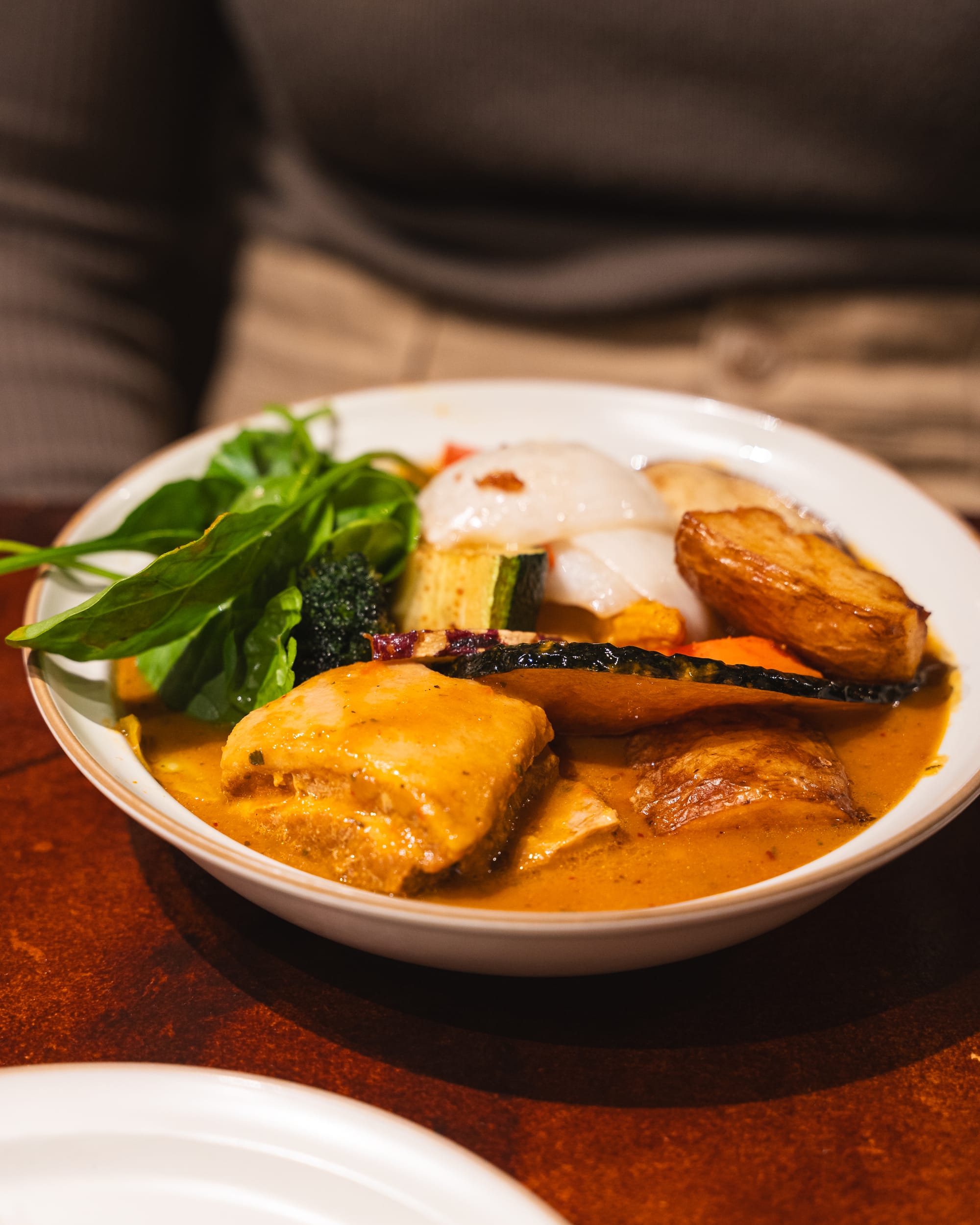 Close up of soup curry with vegetables and braised pork belly